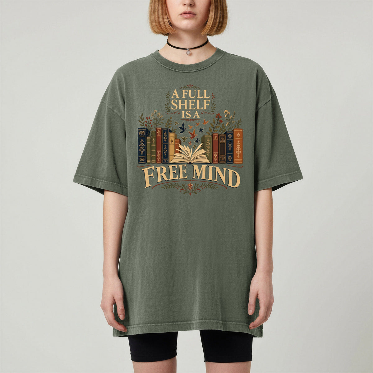 A Full Shelf Is a Free Mind bookish tee in Moss, worn