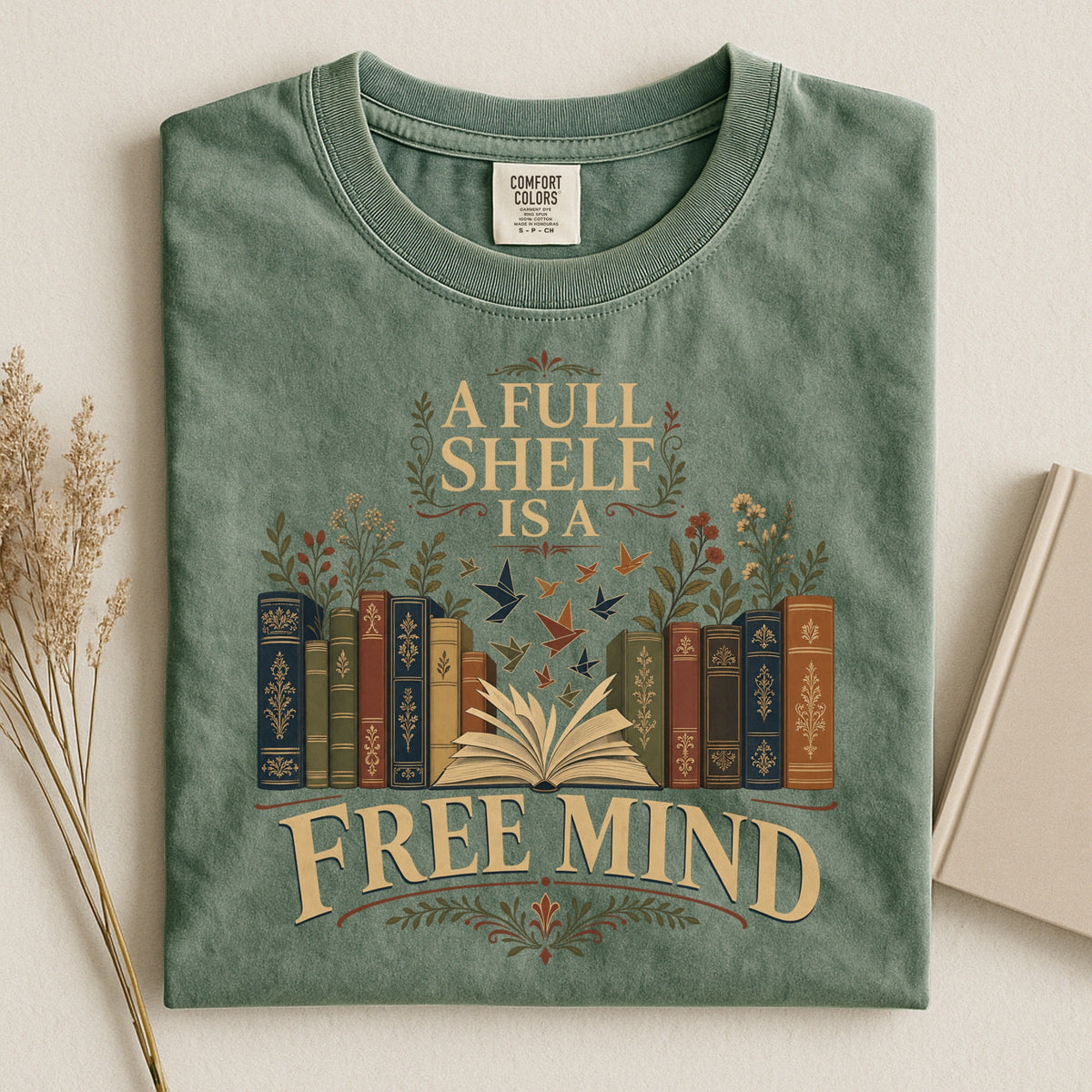 A Full Shelf Is a Free Mind bookish tee in Moss, flat lay