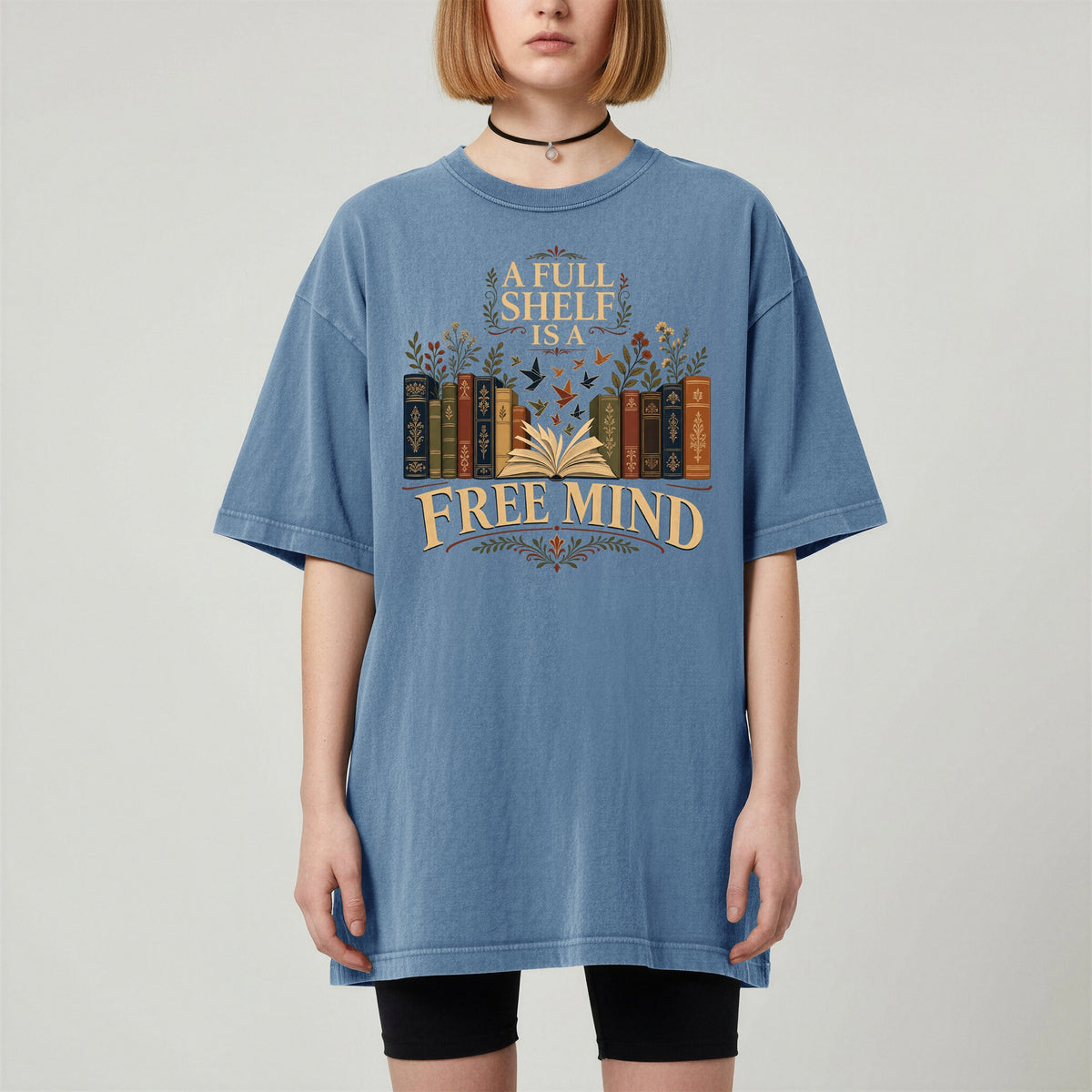 A Full Shelf Is a Free Mind bookish tee in Blue Jean, worn