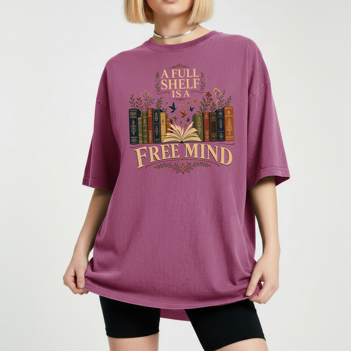 A Full Shelf Is a Free Mind bookish tee in Berry, worn