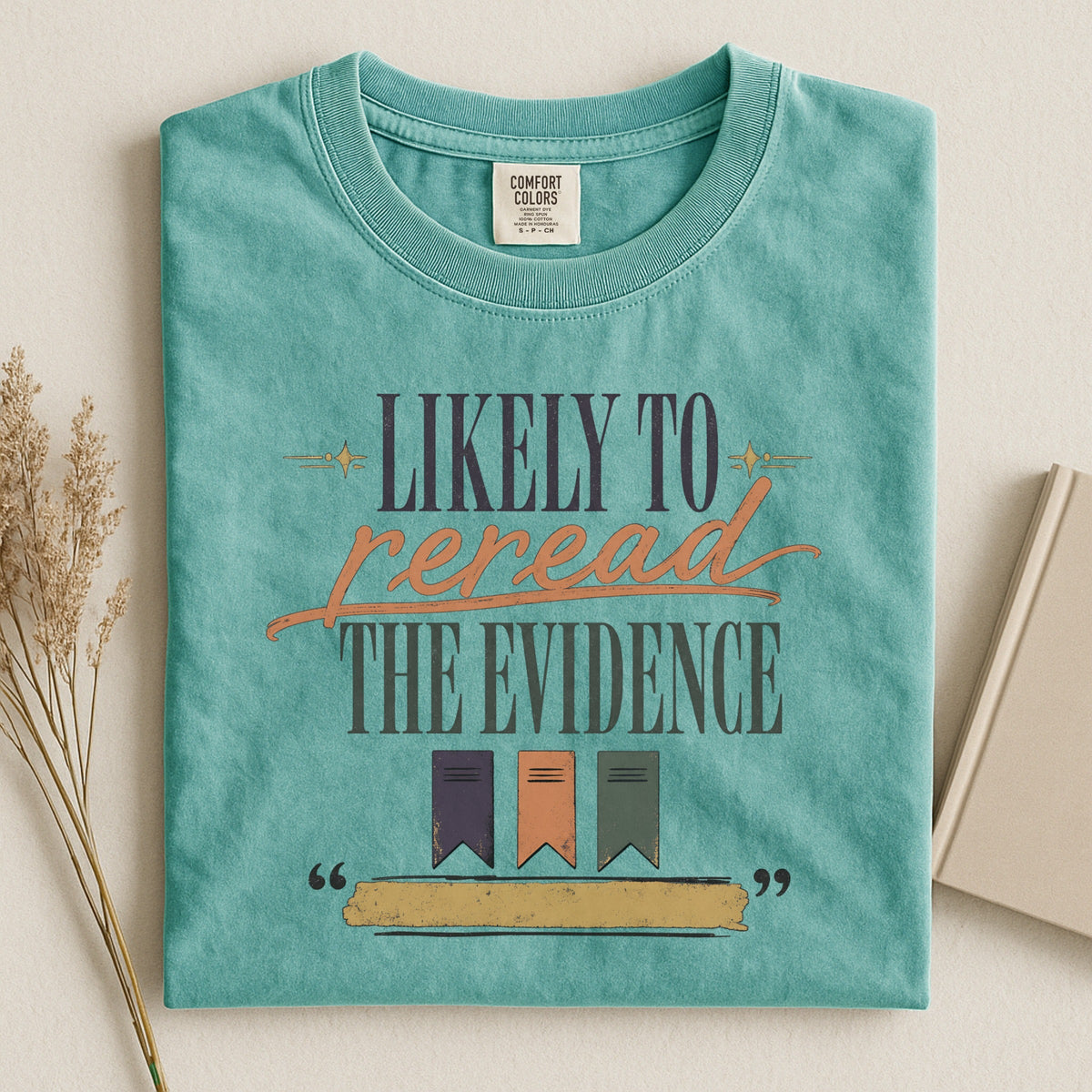 Likely to Reread the Evidence bookish tee in Seafoam, flat lay