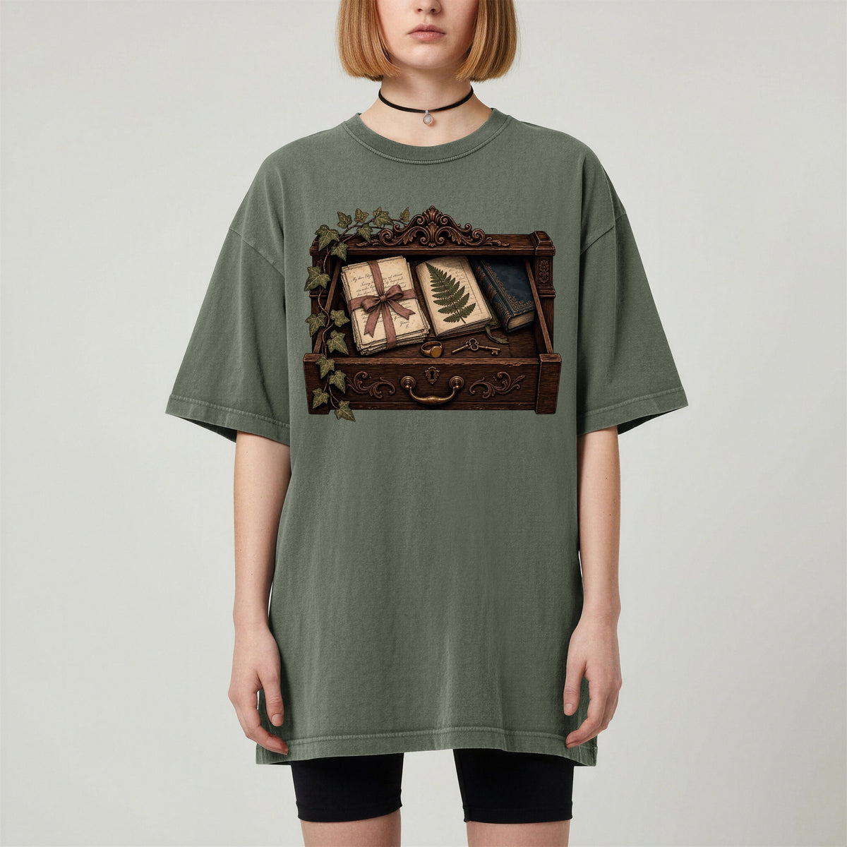 Reader's Keepsake Drawer bookish tee in Moss, worn