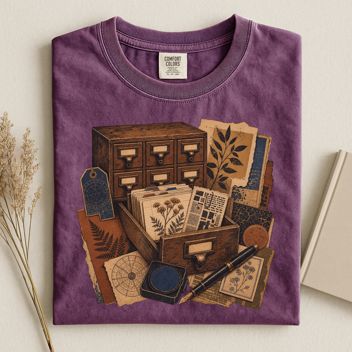 The Card Catalog bookish tee in Berry, flat lay
