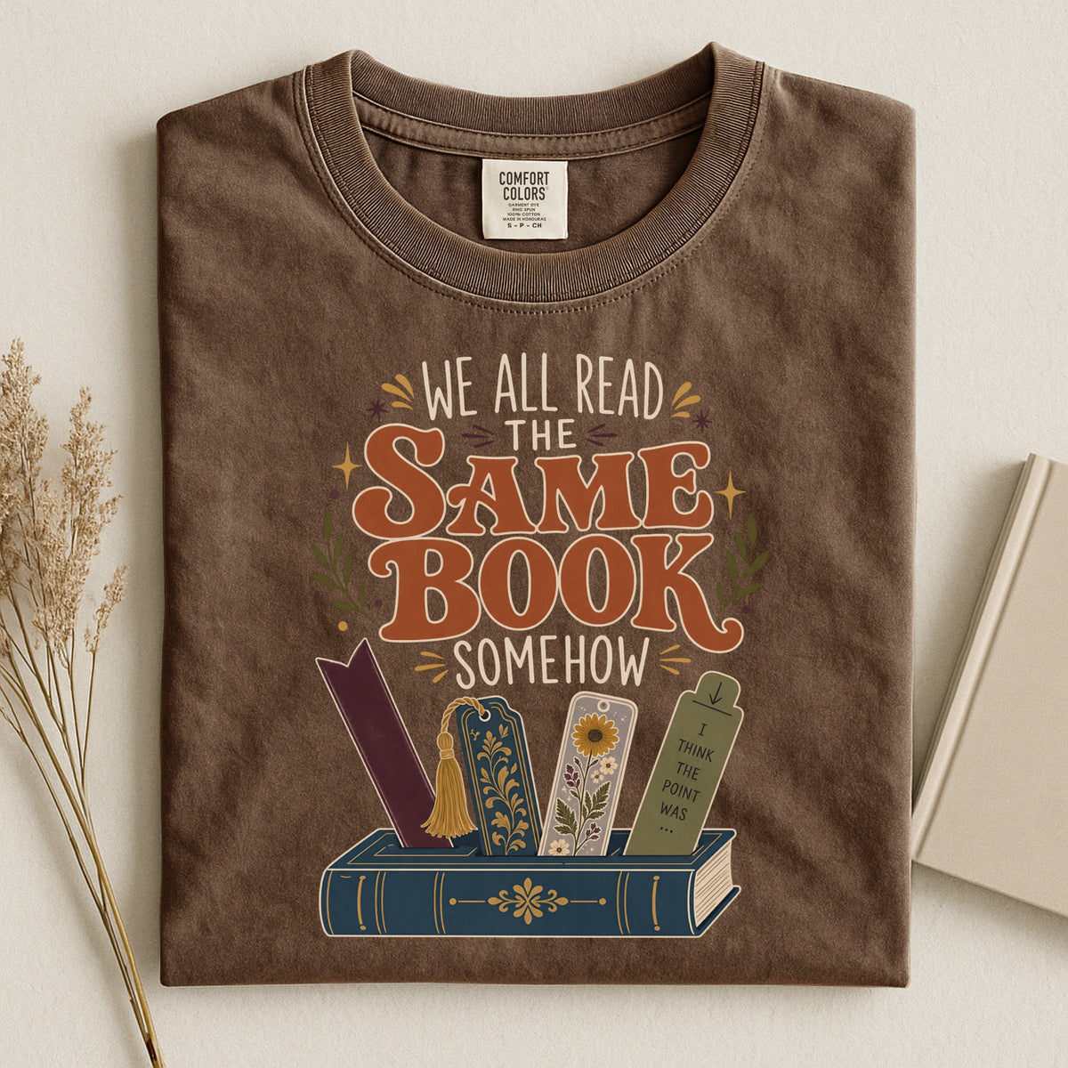 We All Read the Same Book Somehow bookish tee in Espresso, flat lay