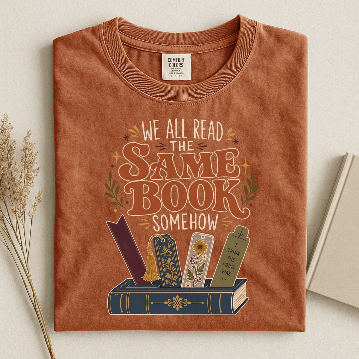 We All Read the Same Book Somehow bookish tee in Yam, flat lay