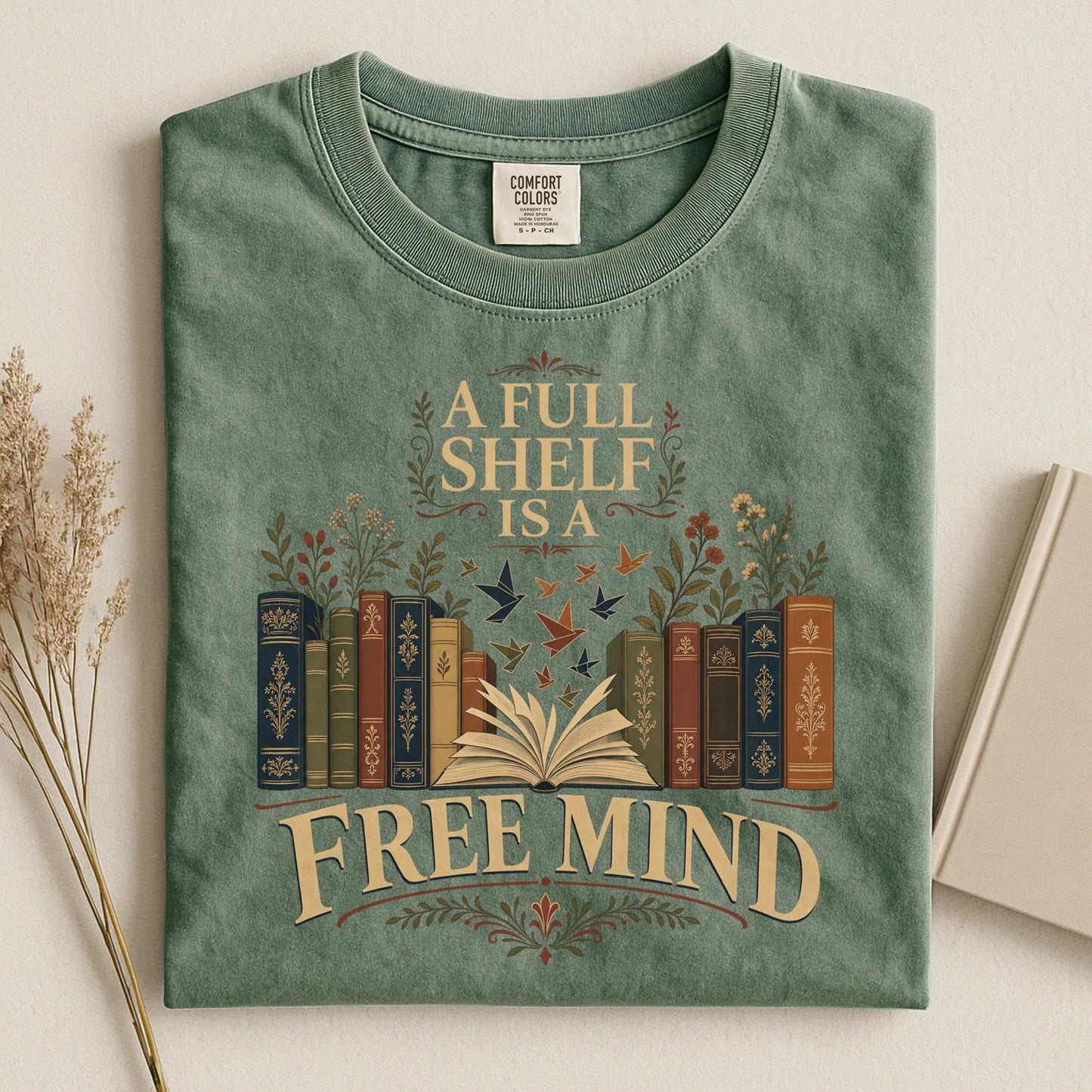 A Full Shelf Is a Free Mind bookish tee in Moss, flat lay