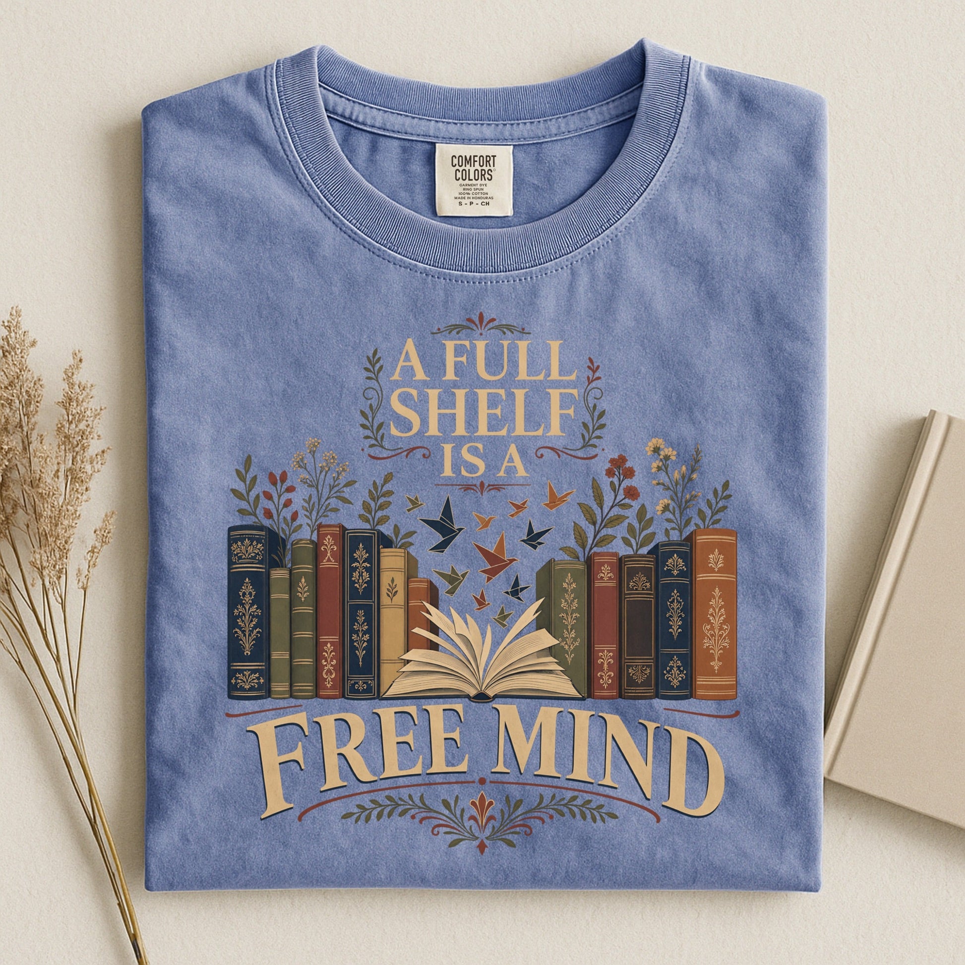 A Full Shelf Is a Free Mind bookish tee in Blue Jean, flat lay
