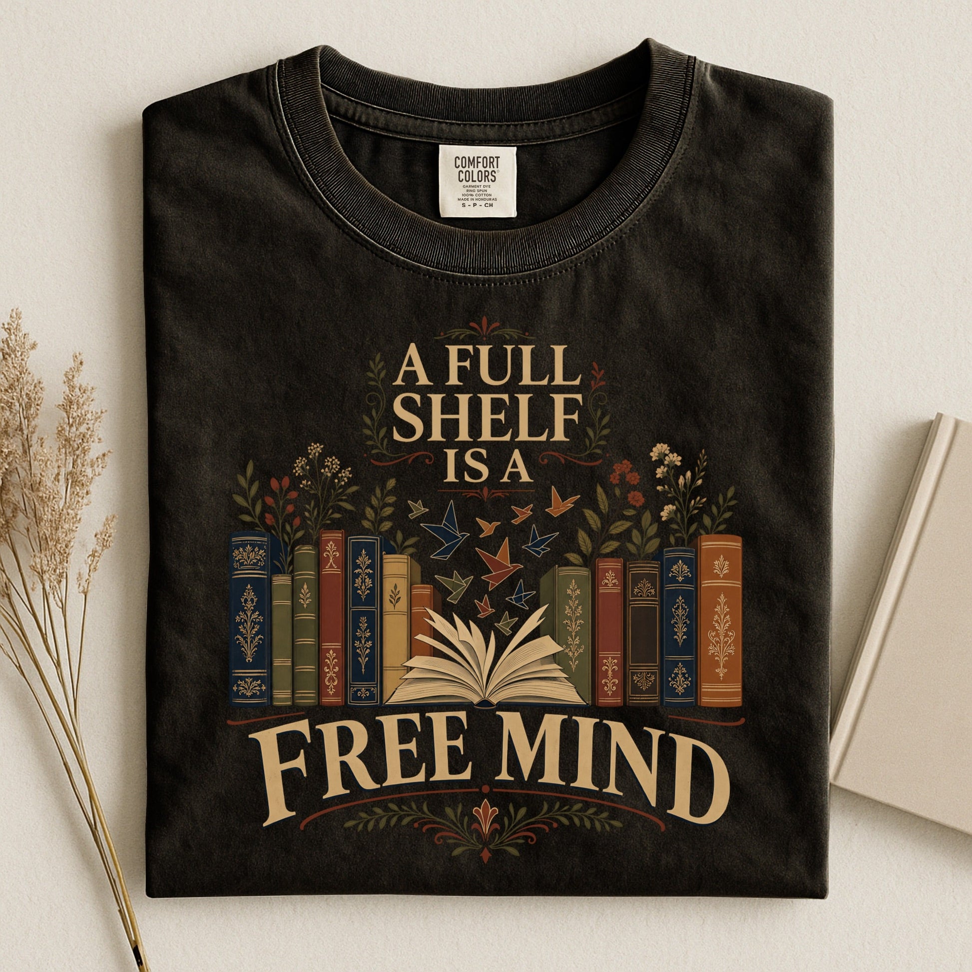 A Full Shelf Is a Free Mind bookish tee in Black, flat lay