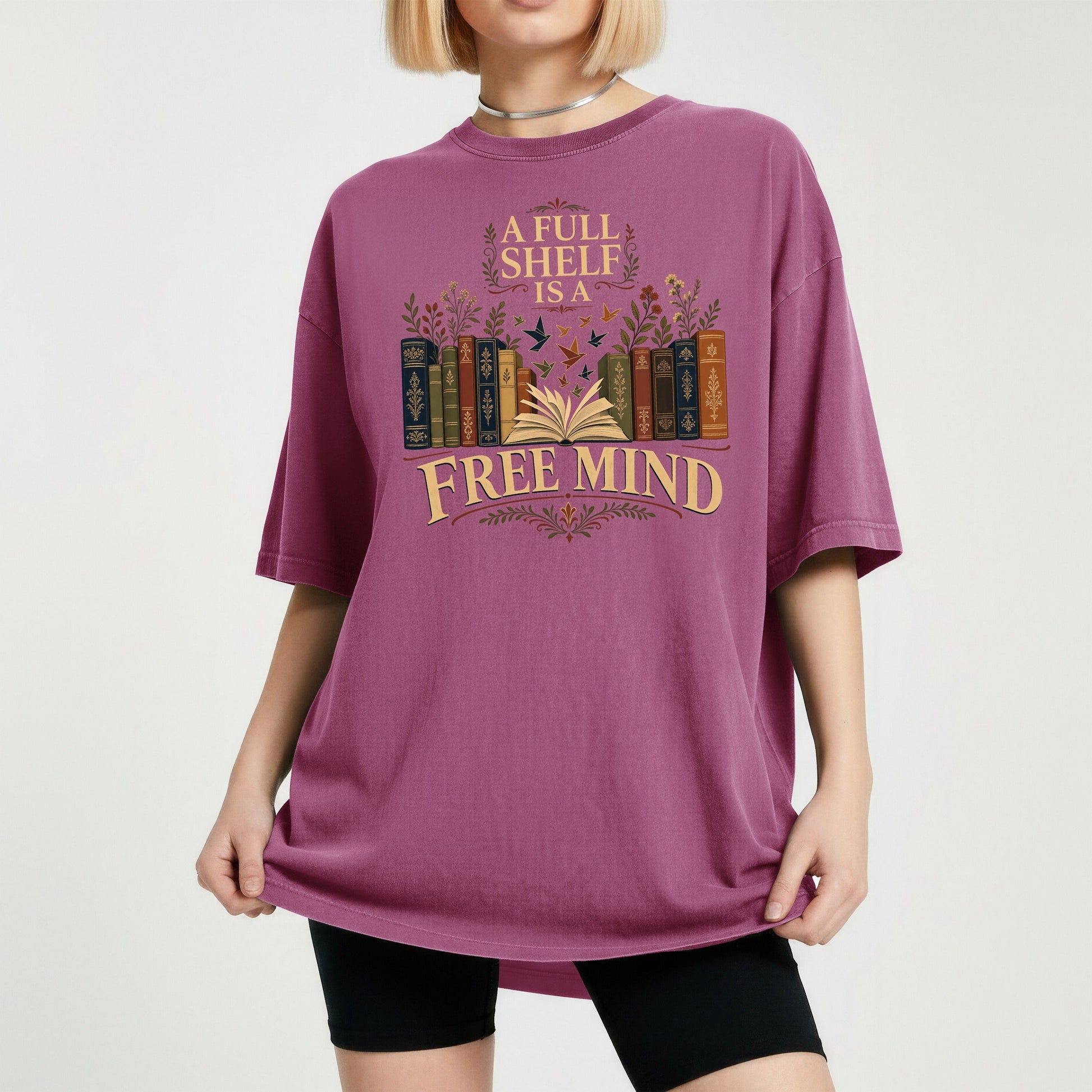 A Full Shelf Is a Free Mind bookish tee in Berry, worn