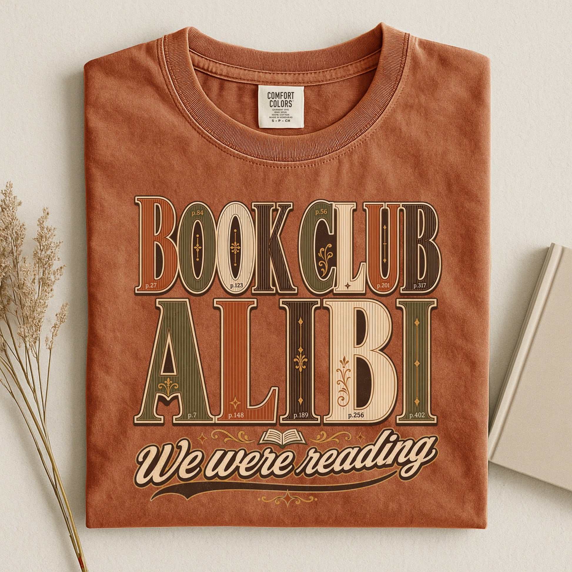 Book Club Alibi bookish tee in Yam, flat lay