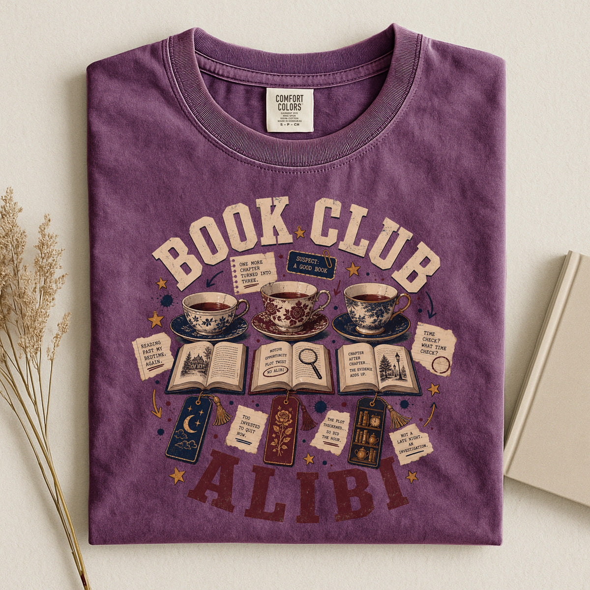 Shelf Love Studio Book Club Alibi t-shirt in Berry, styled flat lay