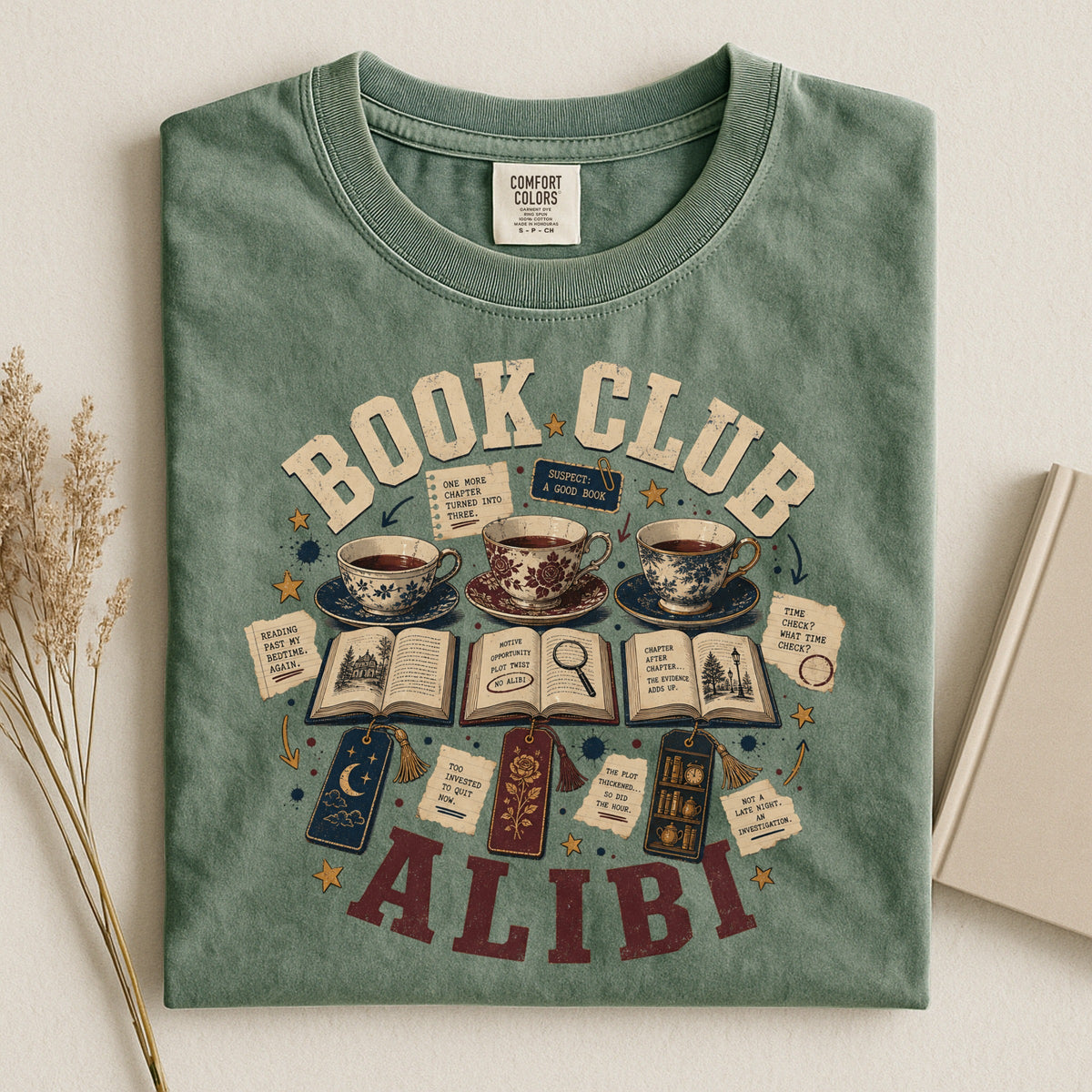 Shelf Love Studio Book Club Alibi t-shirt in Moss, styled flat lay