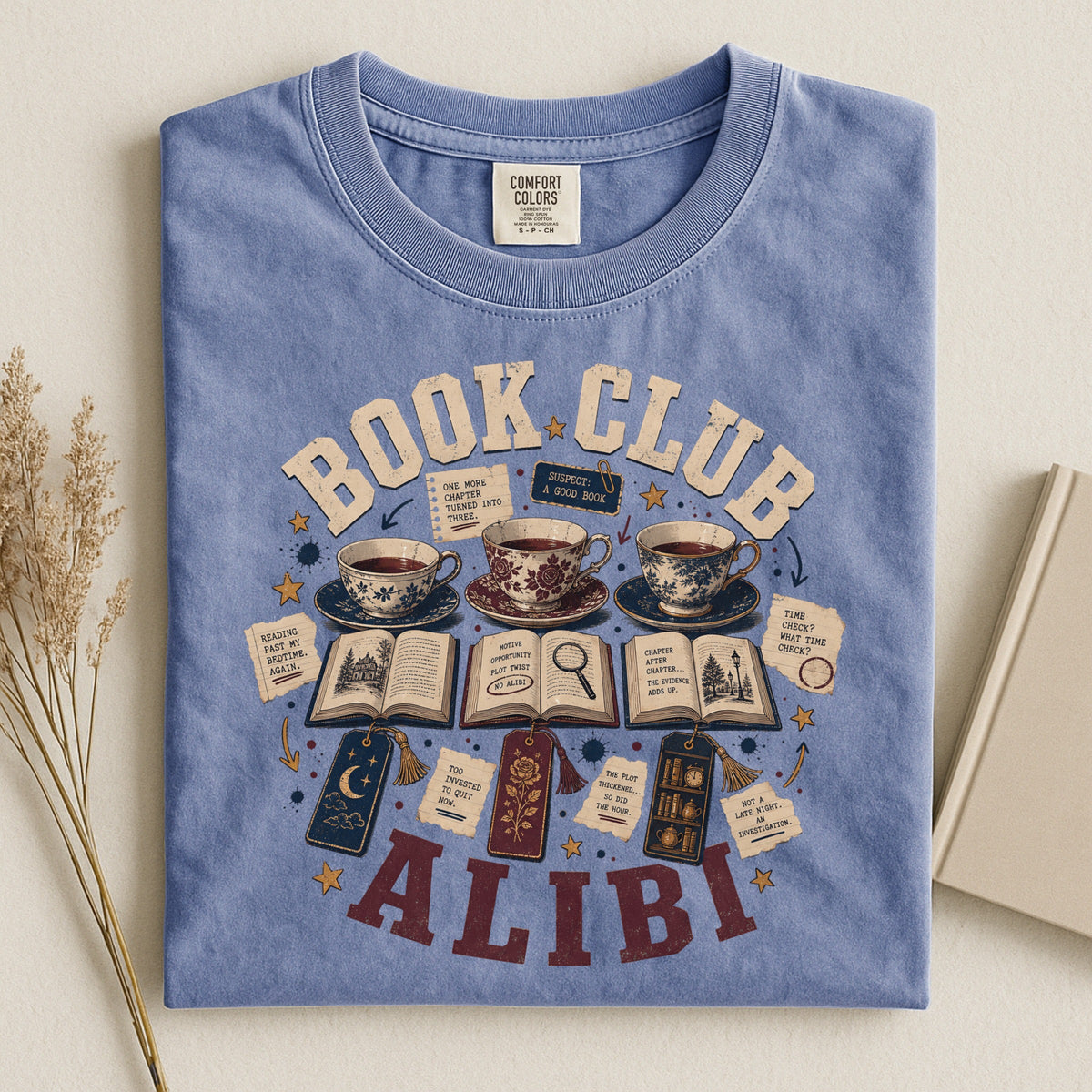 Shelf Love Studio Book Club Alibi t-shirt in Blue Jean, styled flat lay