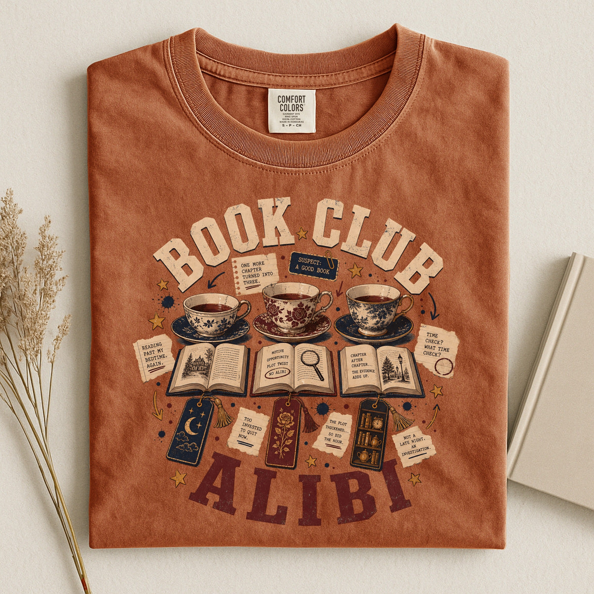 Shelf Love Studio Book Club Alibi t-shirt in Yam, styled flat lay