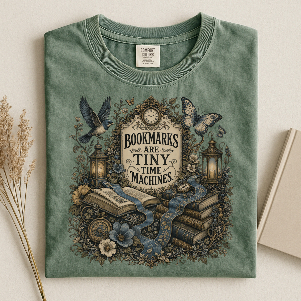 Bookmarks Are Tiny Time Machines bookish tee in Moss, flat lay