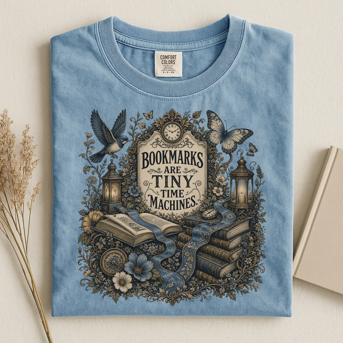 Bookmarks Are Tiny Time Machines bookish tee in Ice Blue, flat lay