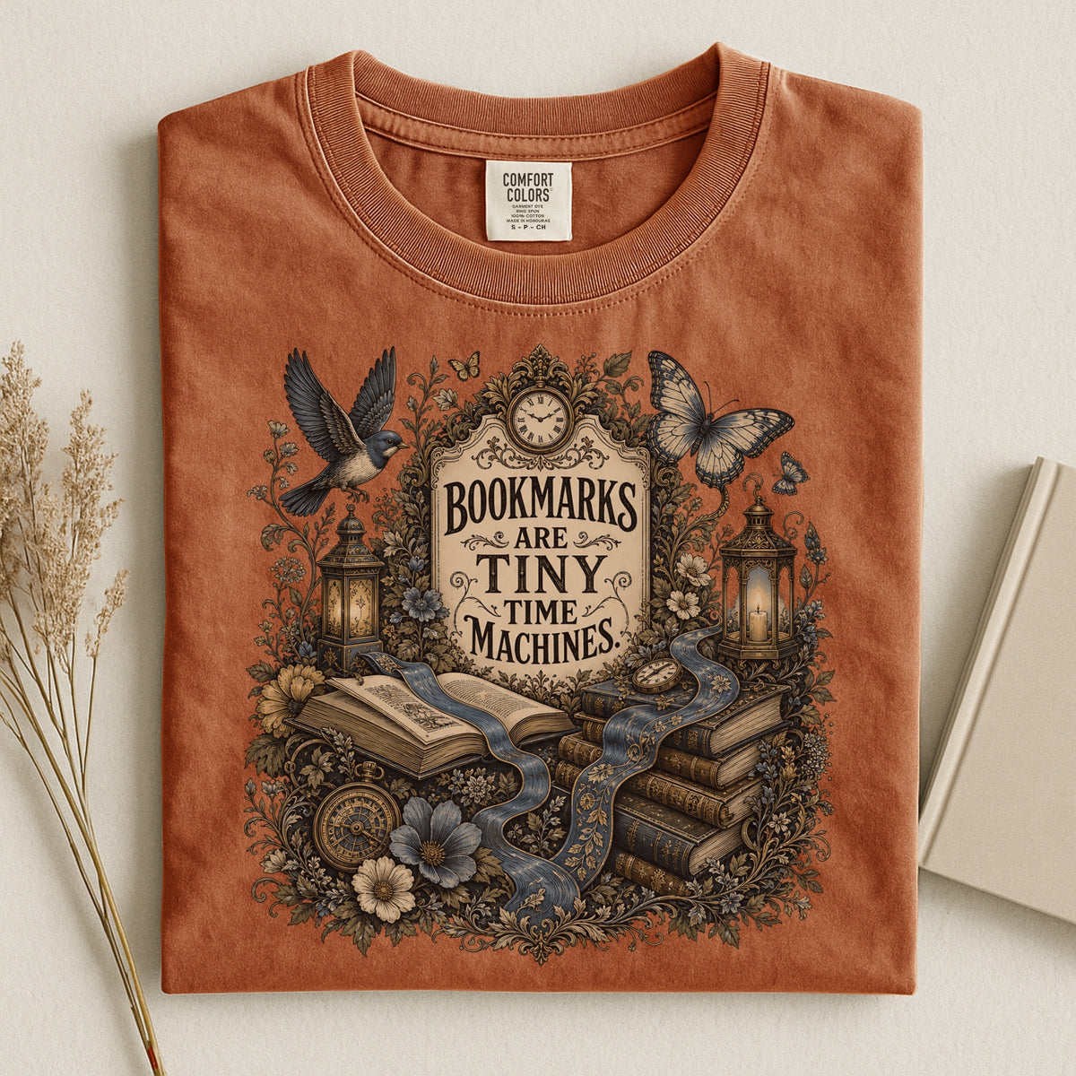 Bookmarks Are Tiny Time Machines bookish tee in Yam, flat lay