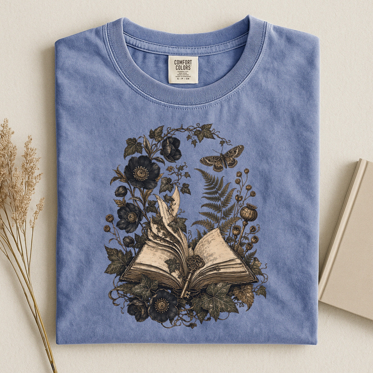 Shelf Love Studio Botanical Open Book t-shirt in Blue Jean, styled flat lay