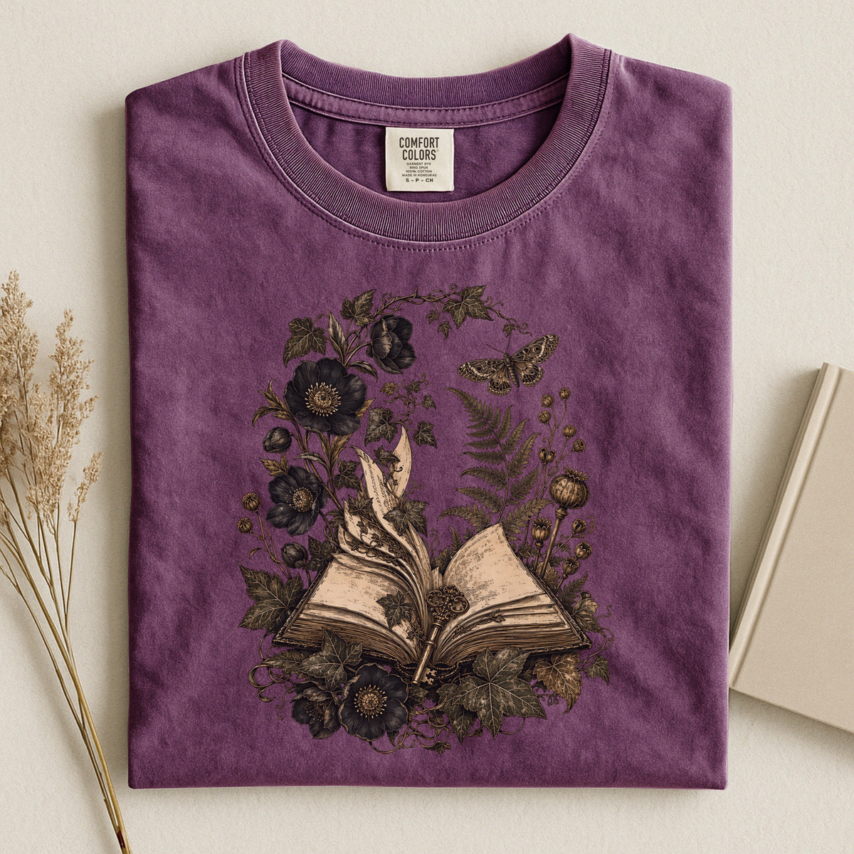 Shelf Love Studio Botanical Open Book t-shirt in Berry, styled flat lay