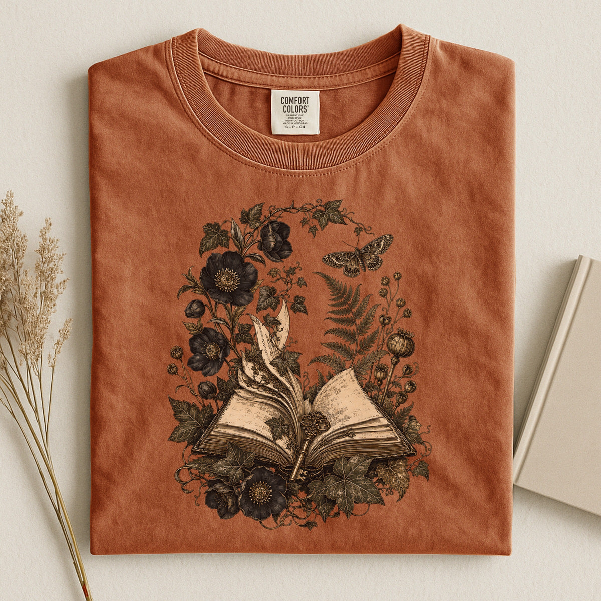 Shelf Love Studio Botanical Open Book t-shirt in Yam, styled flat lay