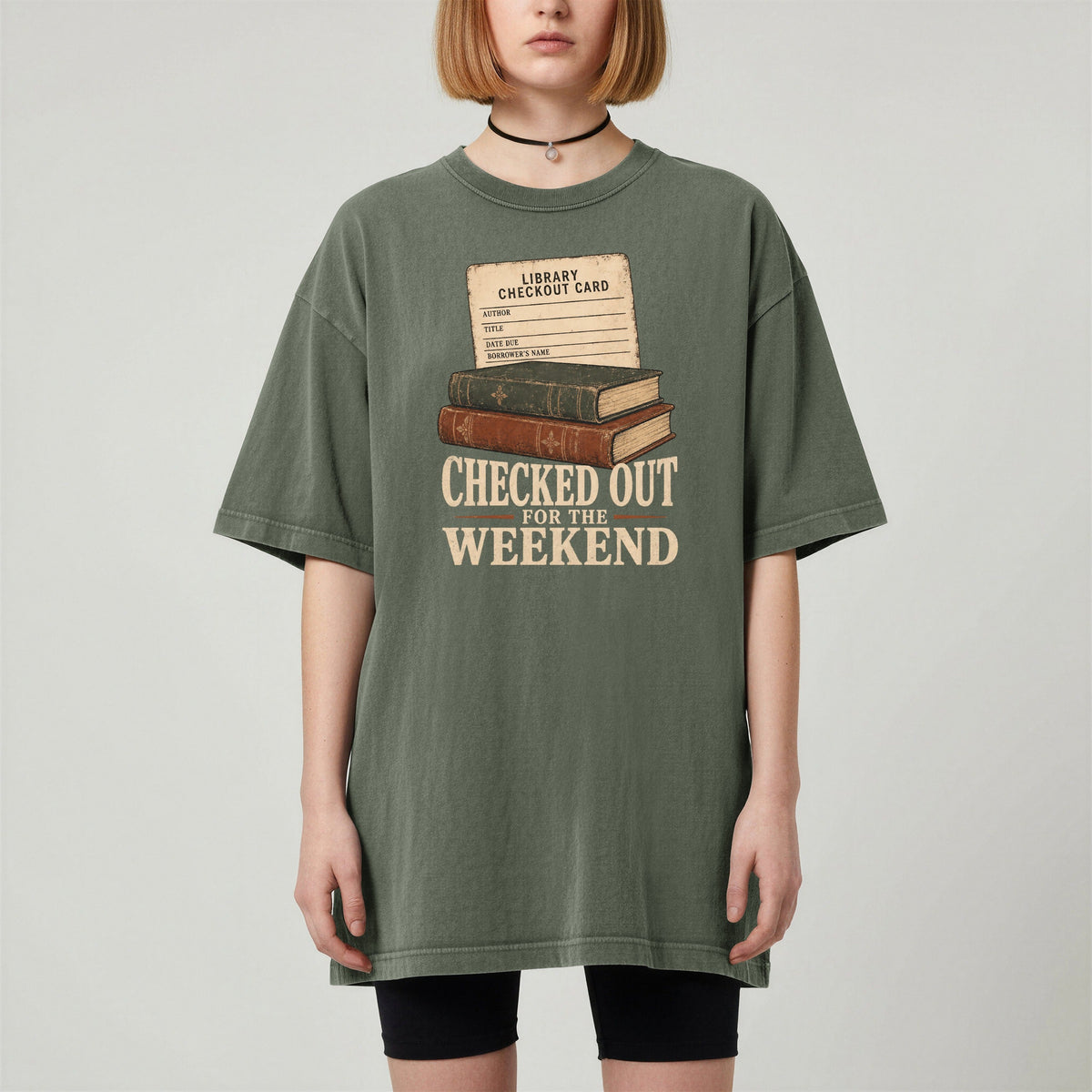 Shelf Love Studio Checked Out for the Weekend t-shirt in Moss, worn