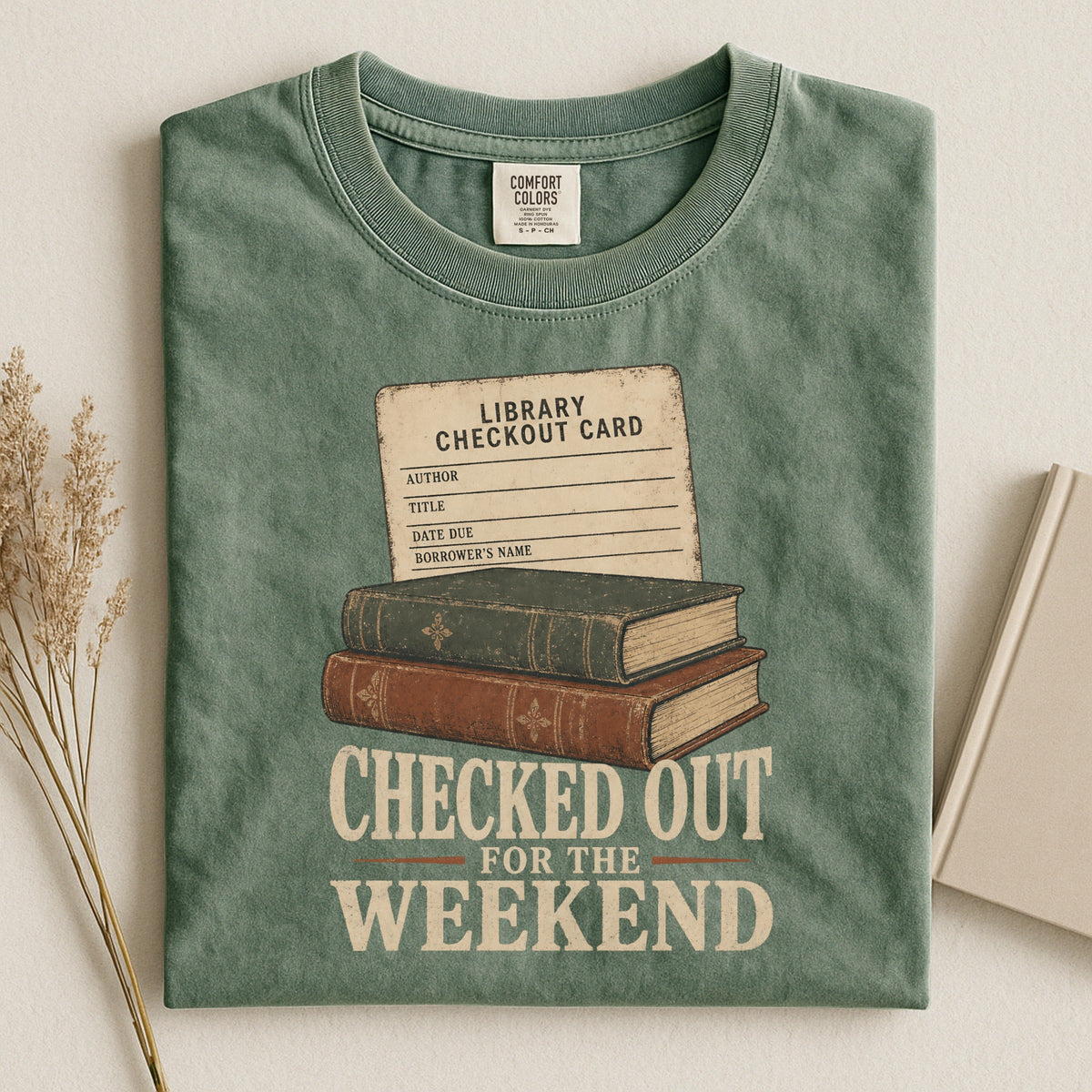 Shelf Love Studio Checked Out for the Weekend t-shirt in Moss, styled flat lay