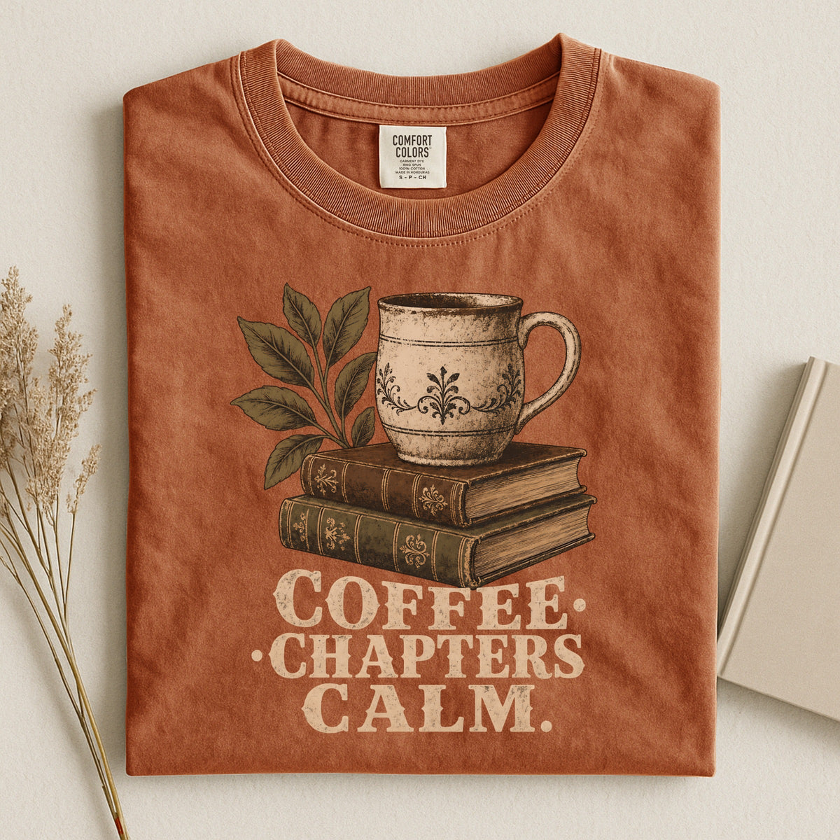 Shelf Love Studio Coffee. Chapters. Calm. t-shirt in Yam, styled flat lay