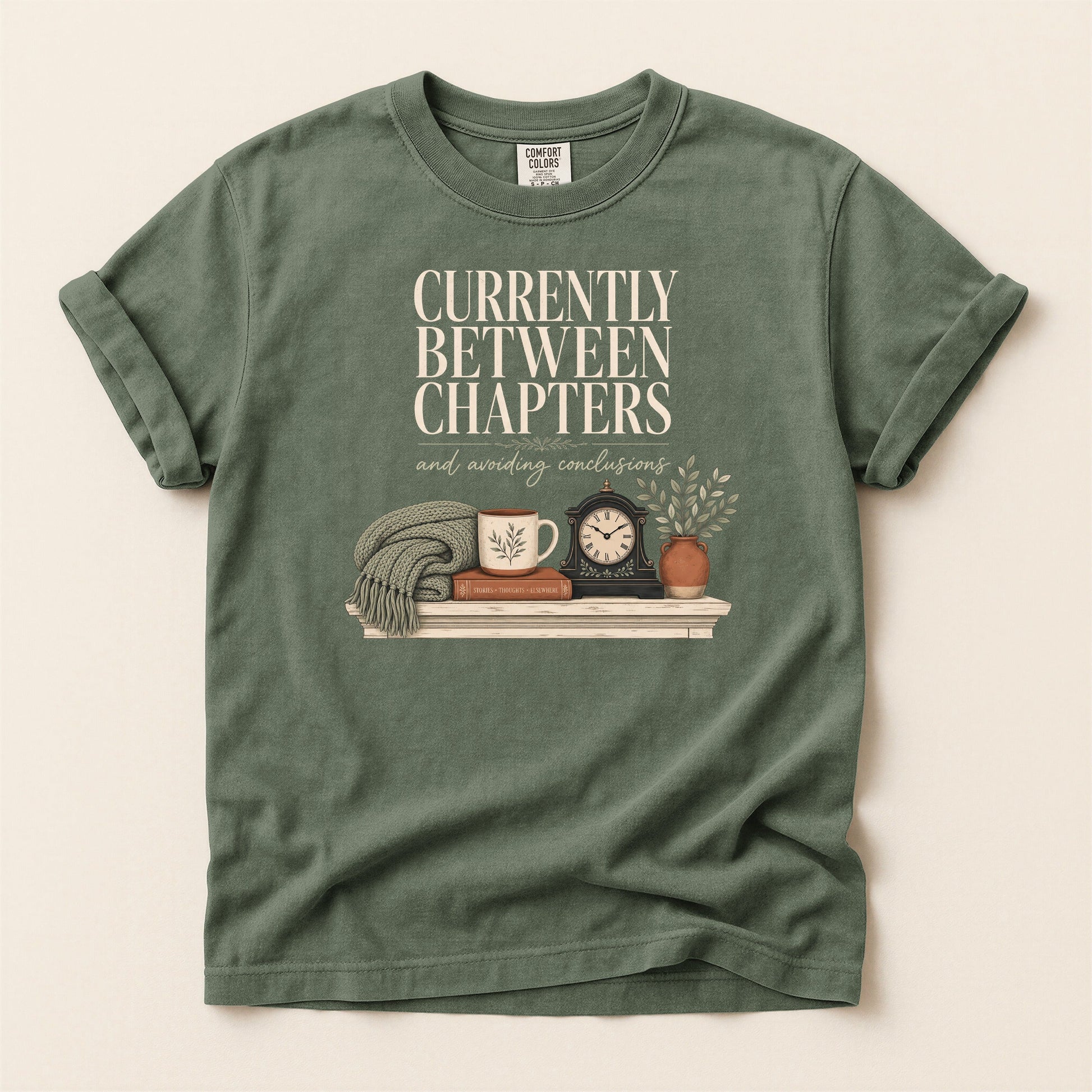 Currently Between Chapters bookish tee in Moss, full flat