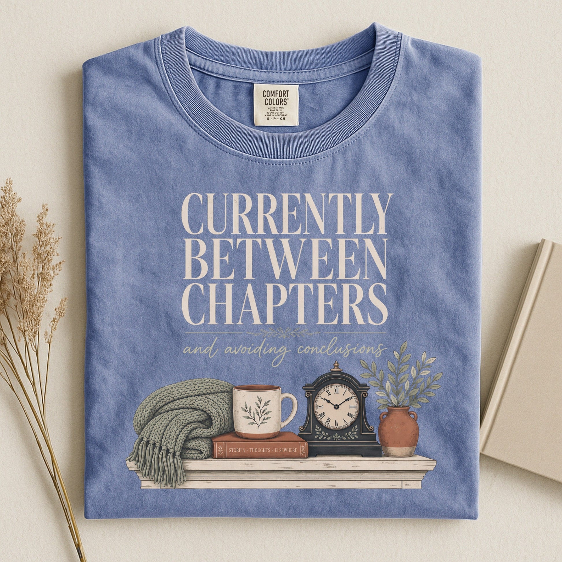 Currently Between Chapters bookish tee in Blue Jean, flat lay