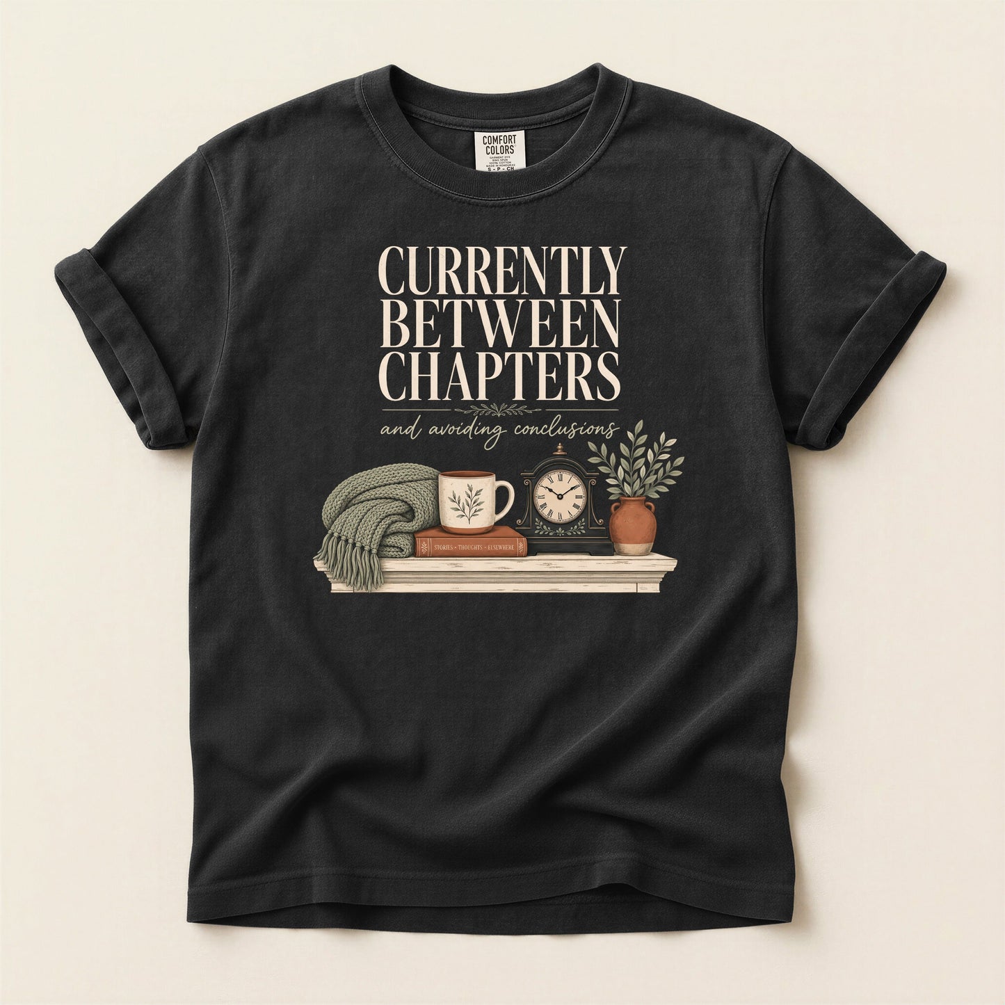 Currently Between Chapters bookish tee in Black, full flat