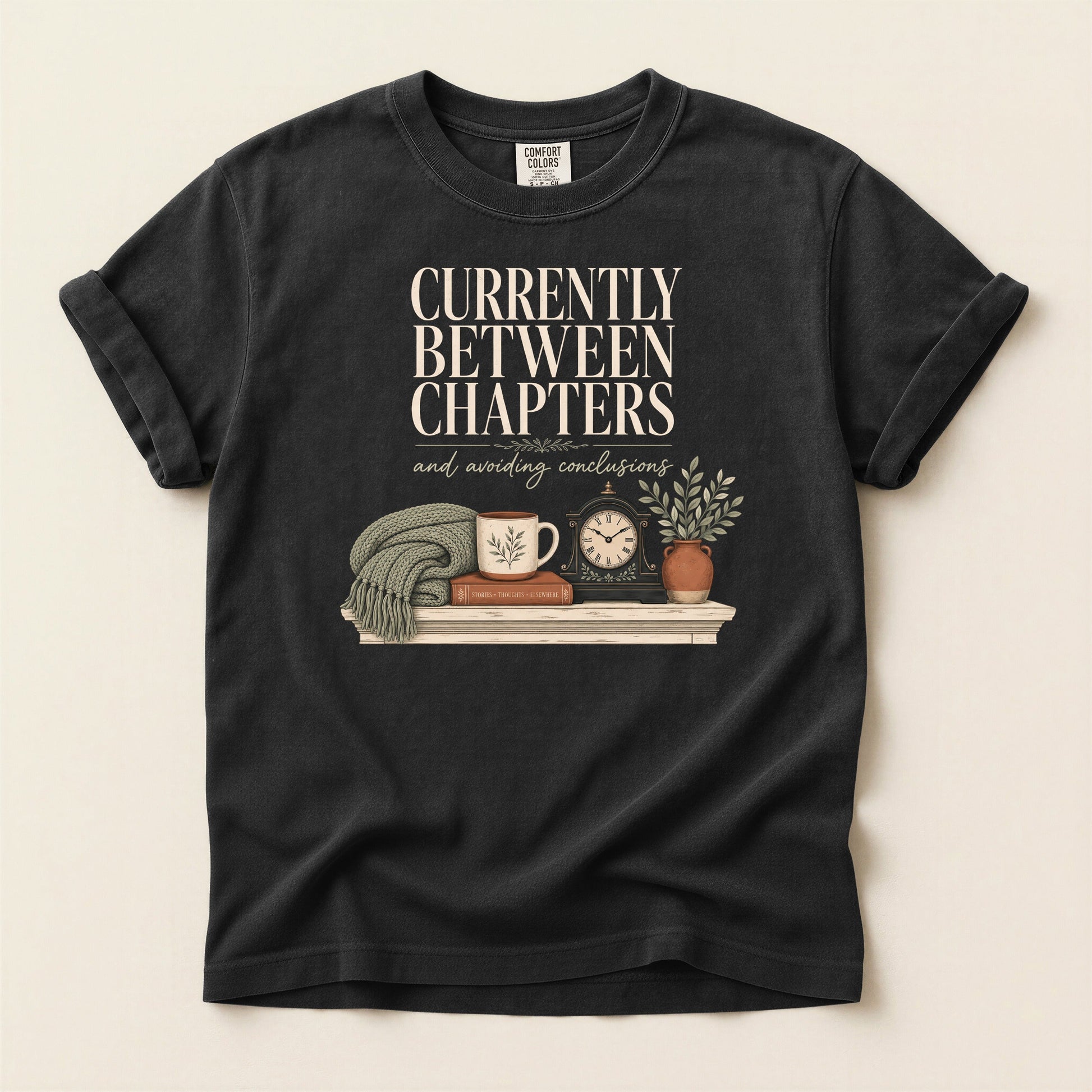 Currently Between Chapters bookish tee in Black, full flat