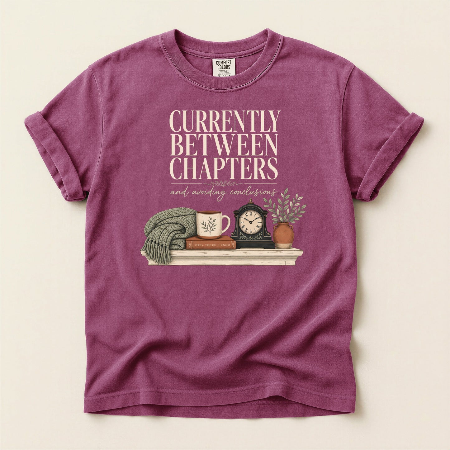 Currently Between Chapters bookish tee in Berry, full flat