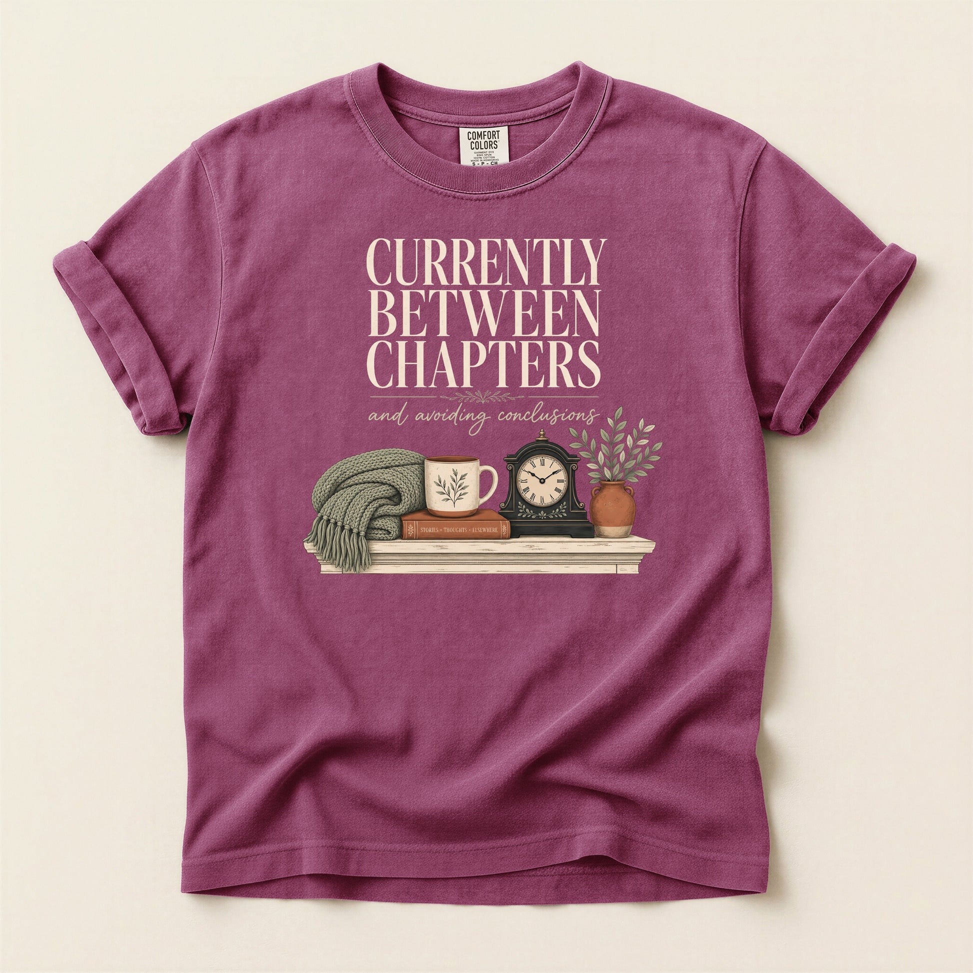 Currently Between Chapters bookish tee in Berry, full flat