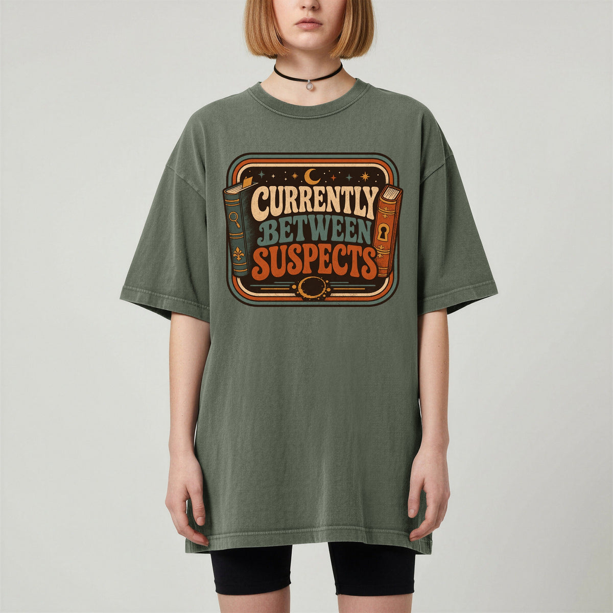 Shelf Love Studio Currently Between Suspects t-shirt in Moss, worn