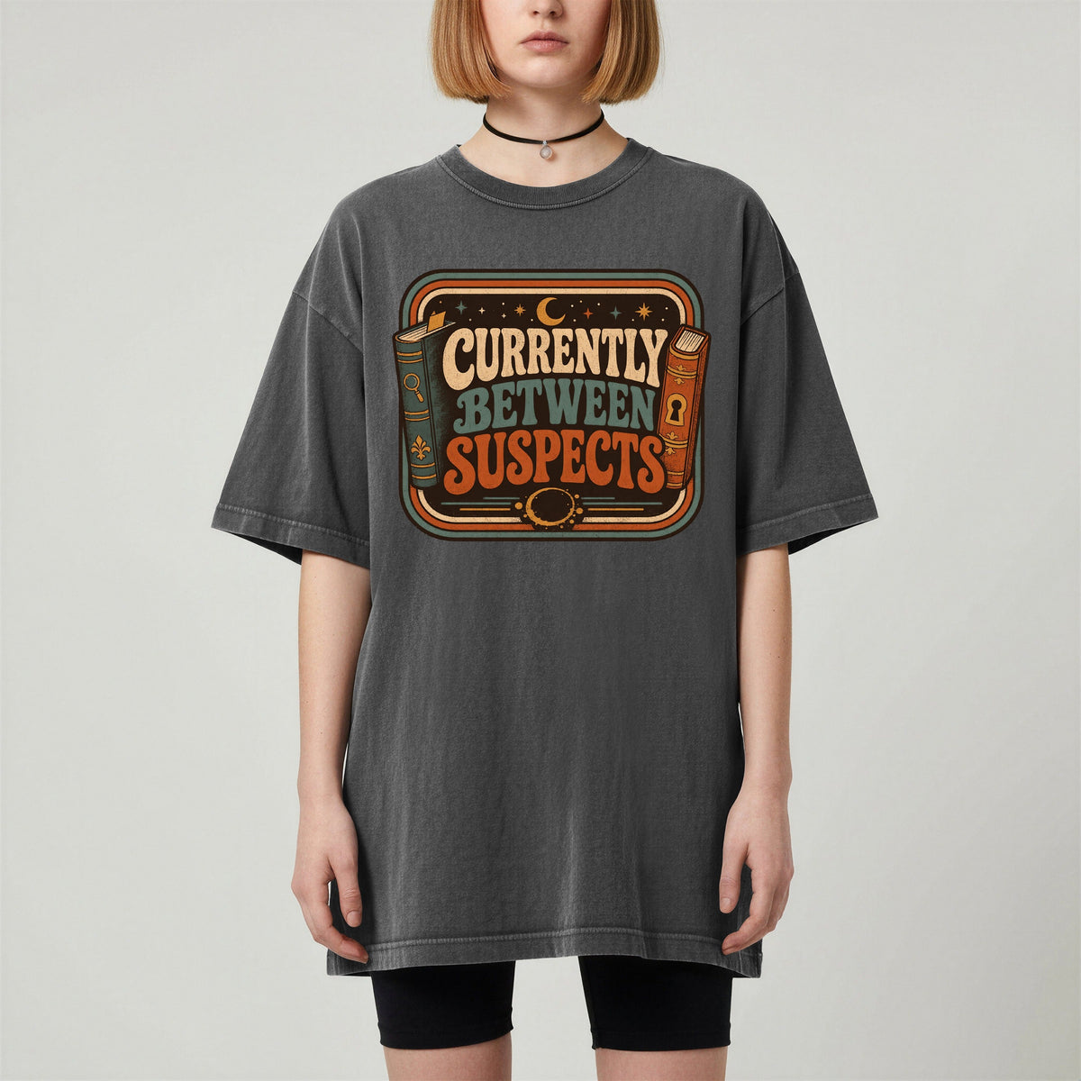 Shelf Love Studio Currently Between Suspects t-shirt in Pepper, worn