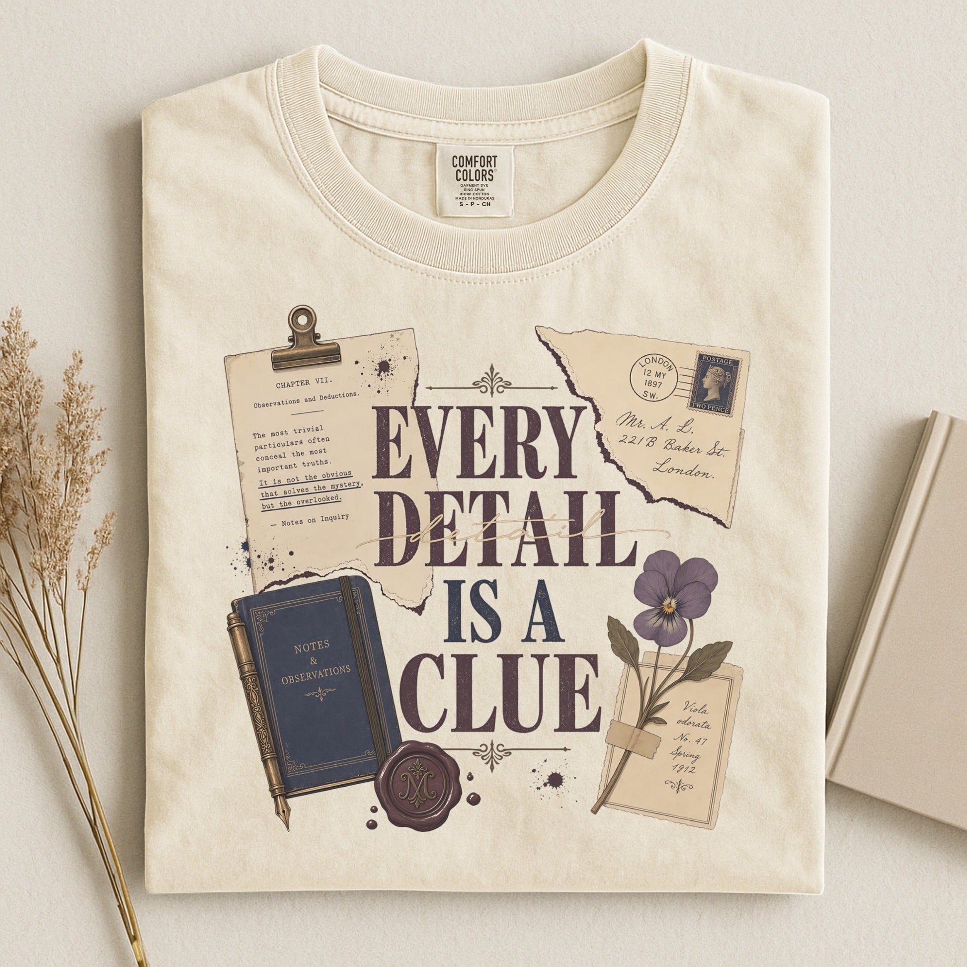Every Detail Is a Clue bookish tee in Ivory, flat lay