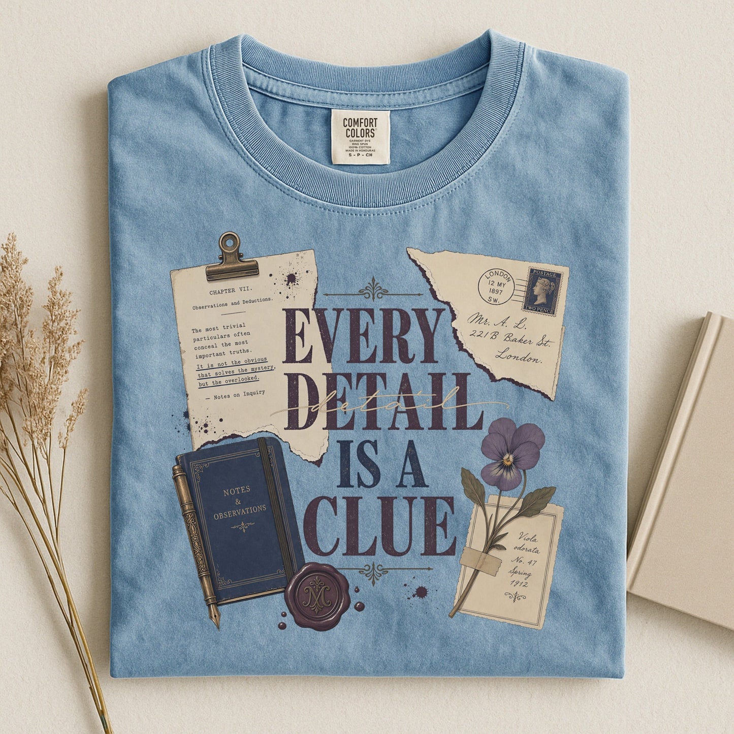 Every Detail Is a Clue bookish tee in Ice Blue, flat lay