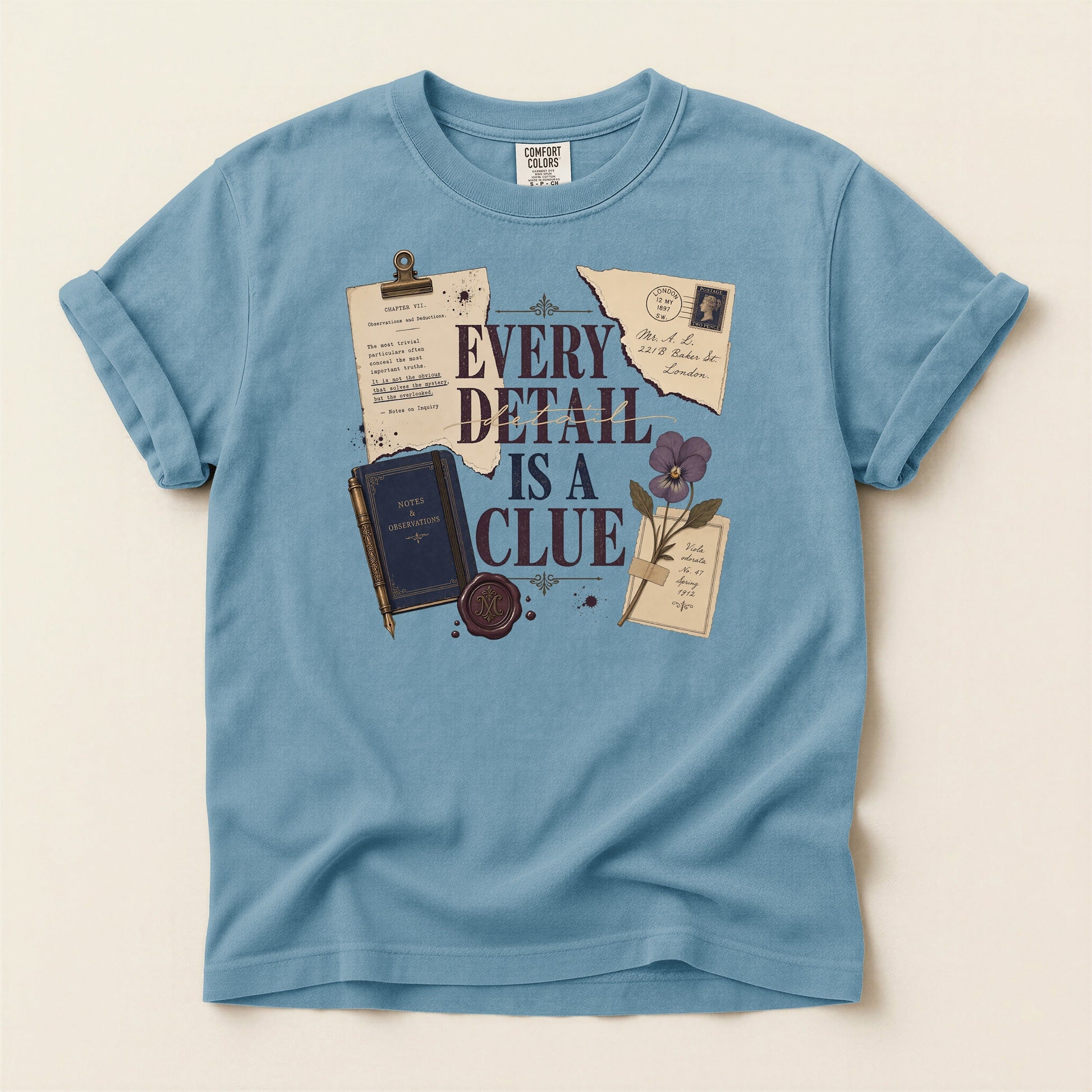 Every Detail Is a Clue bookish tee in Ice Blue, full flat