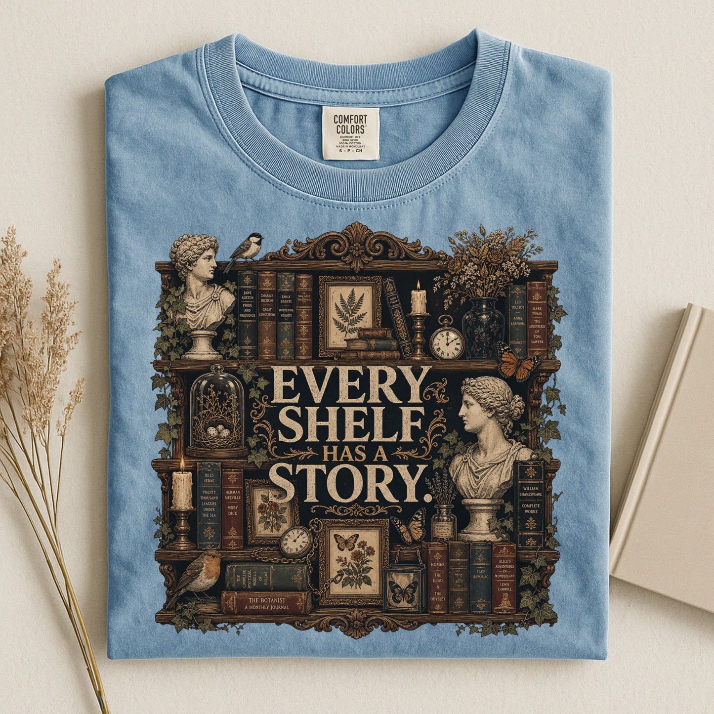Every Shelf Has a Story bookish tee in Ice Blue, flat lay