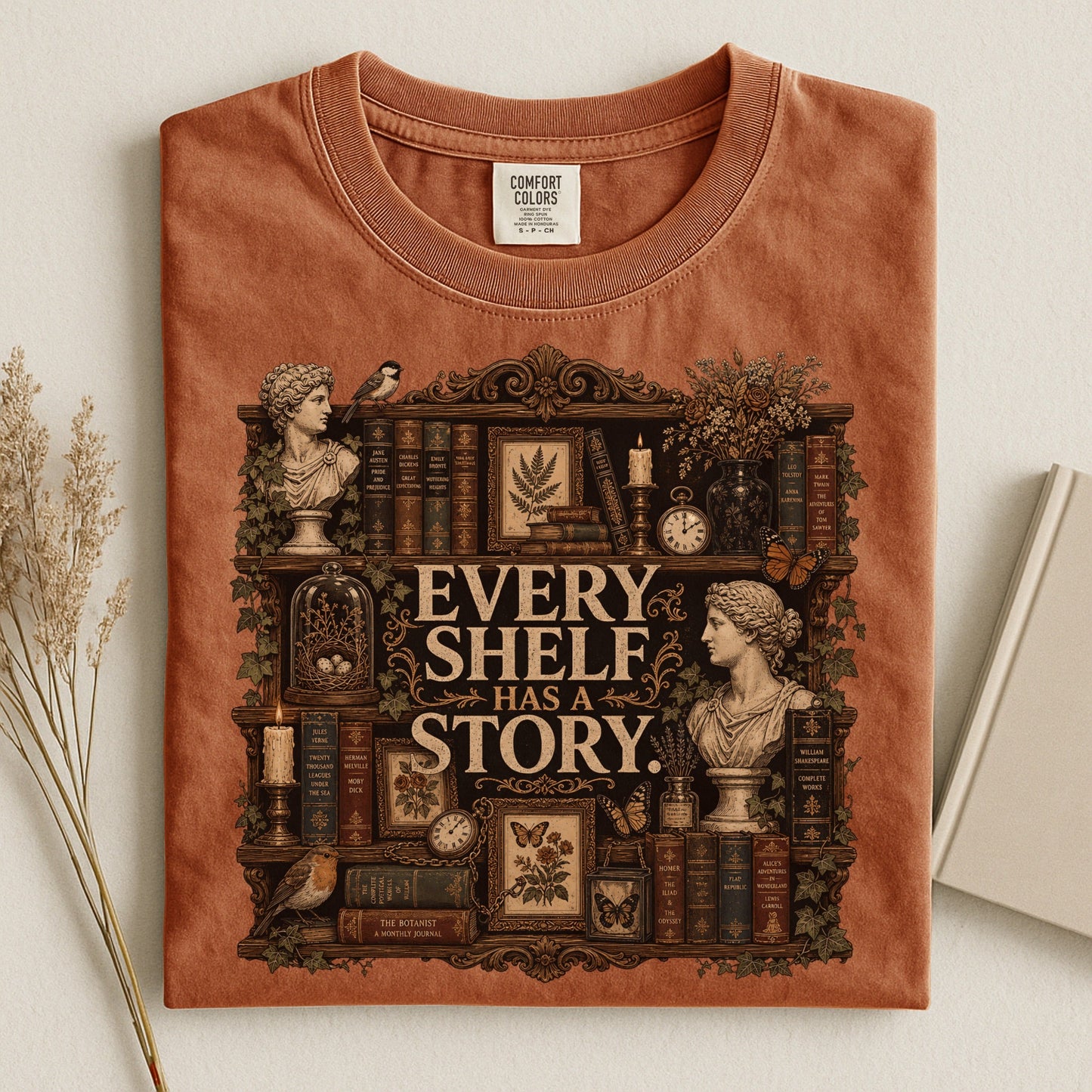 Every Shelf Has a Story bookish tee in Yam, flat lay