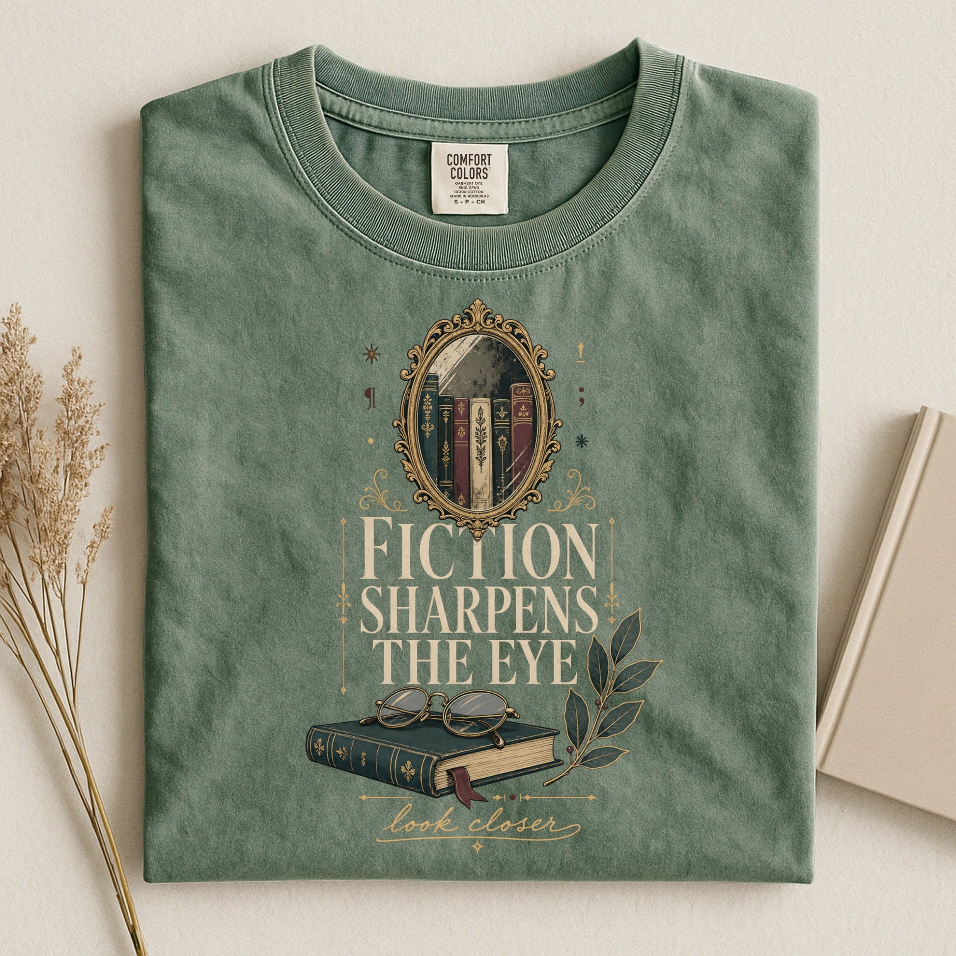 Fiction Sharpens the Eye bookish tee in Moss, flat lay