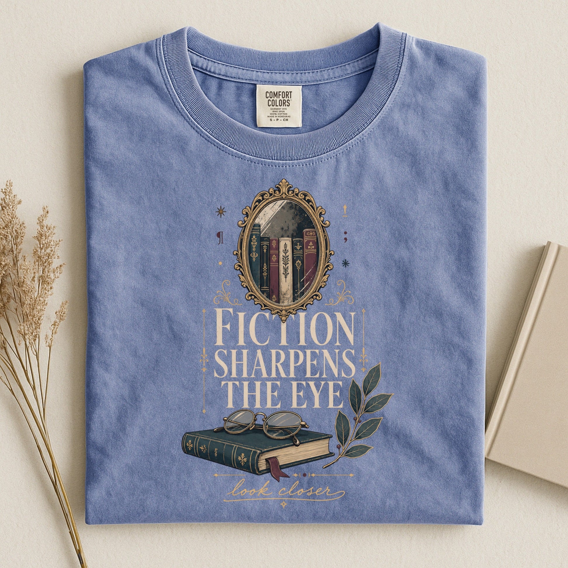 Fiction Sharpens the Eye bookish tee in Blue Jean, flat lay