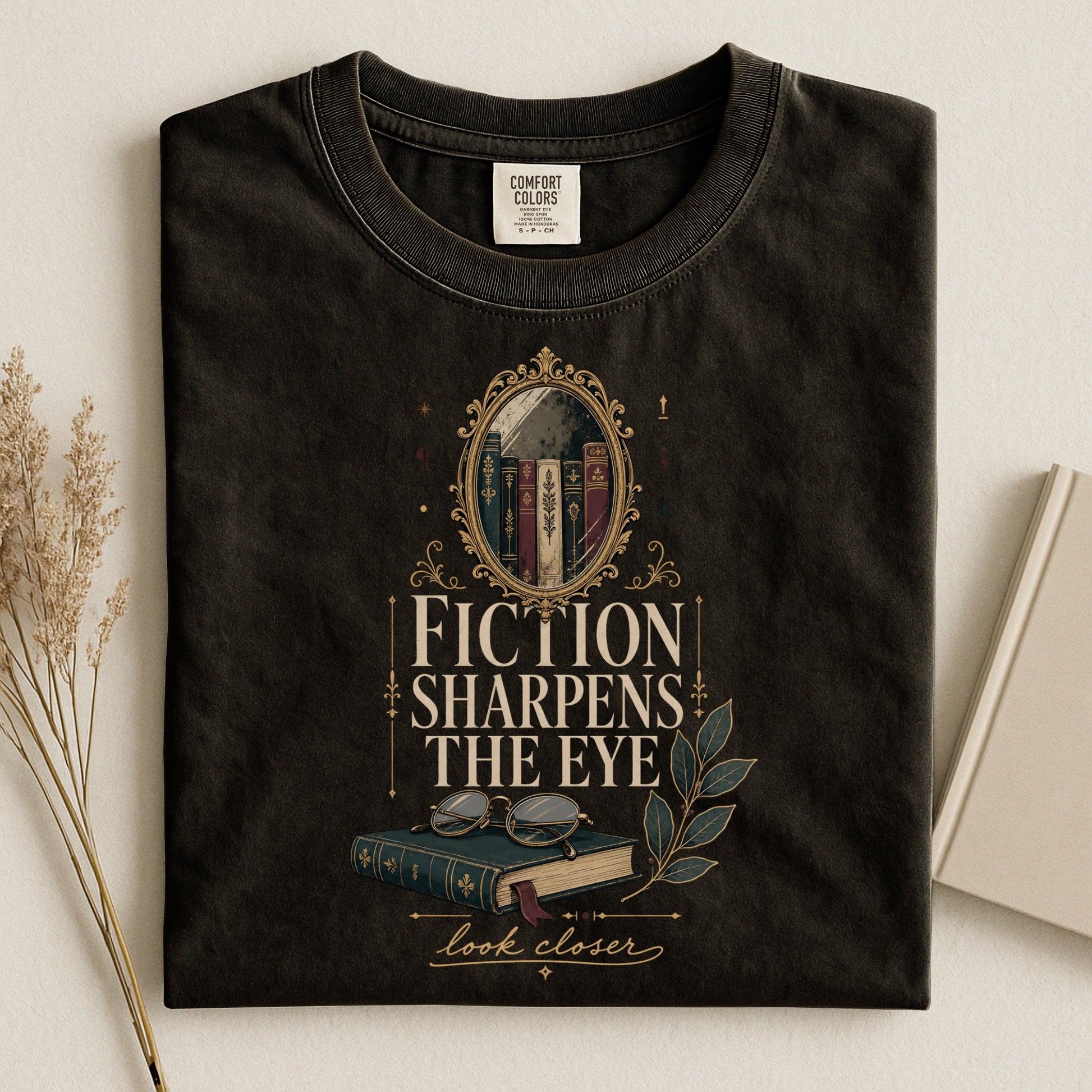 Fiction Sharpens the Eye bookish tee in Black, flat lay