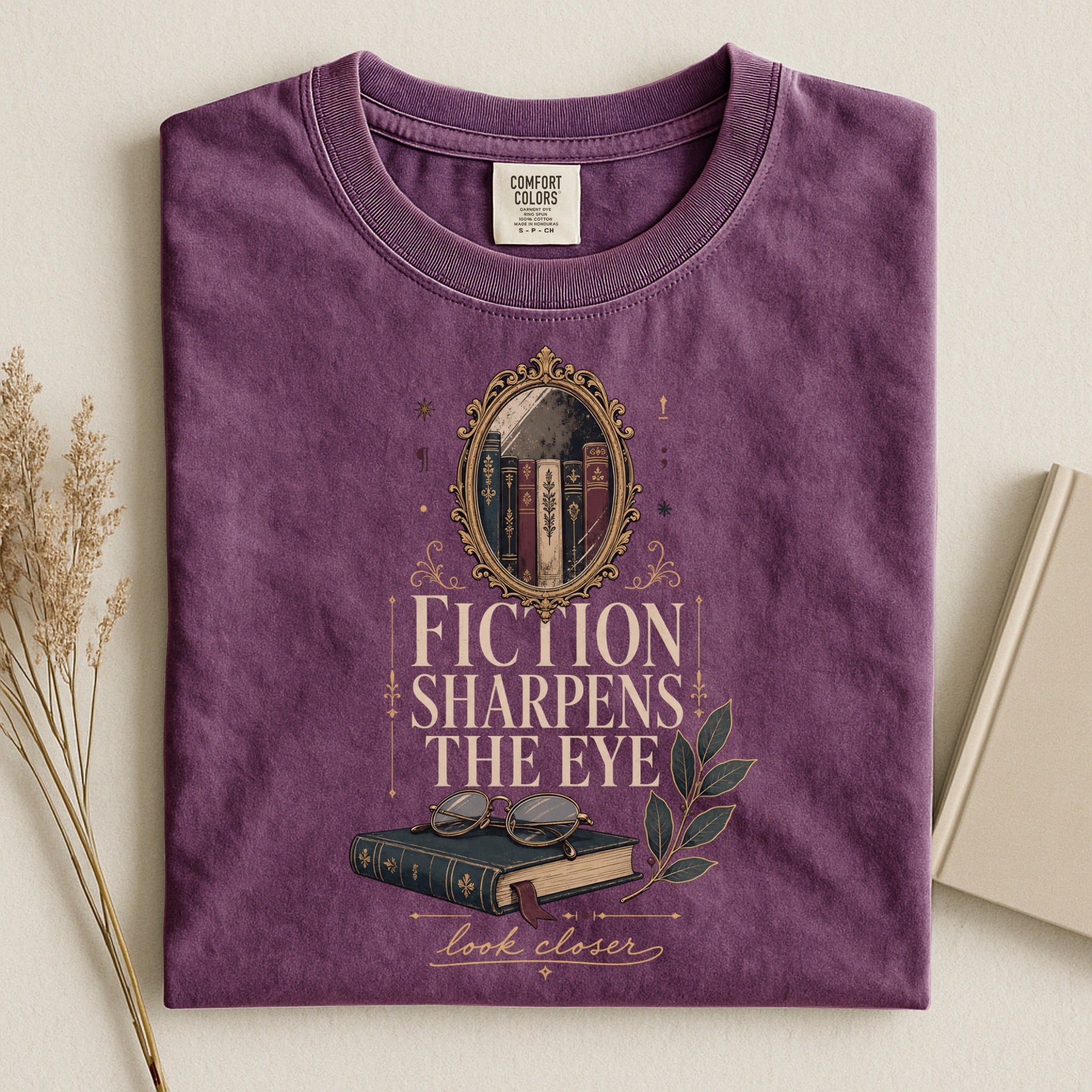 Fiction Sharpens the Eye bookish tee in Berry, flat lay
