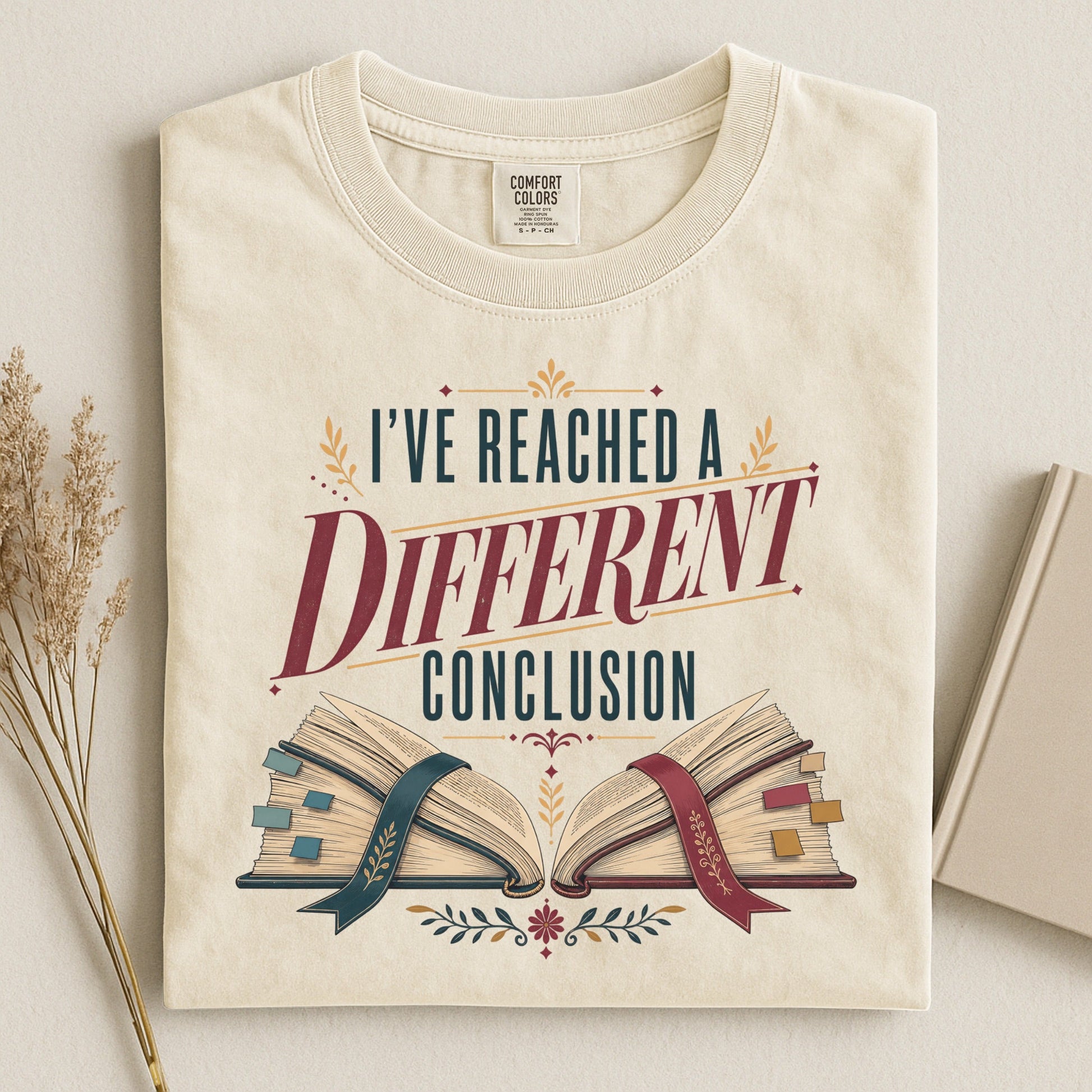 I've Reached a Different Conclusion bookish tee in Ivory, flat lay