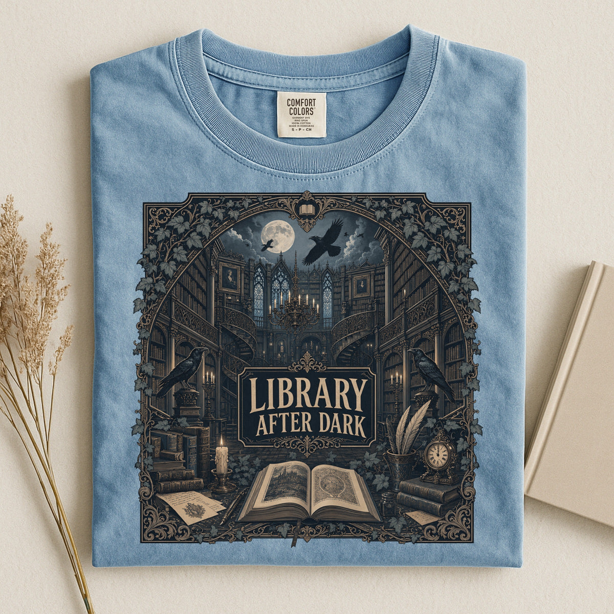 Library After Dark bookish tee in Ice Blue, flat lay