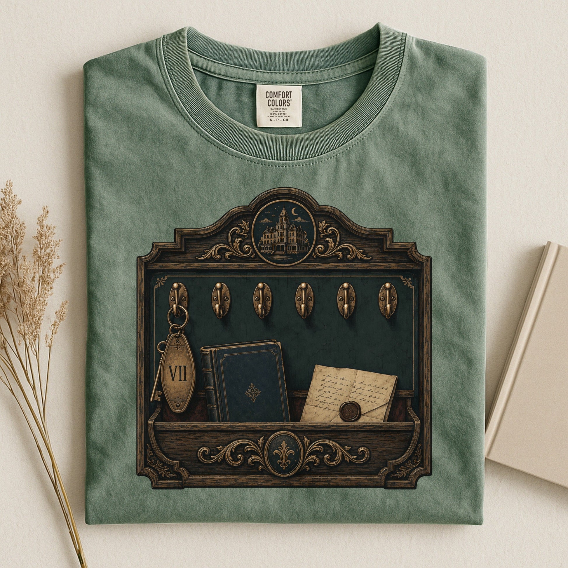 Library Key Board bookish tee in Moss, flat lay