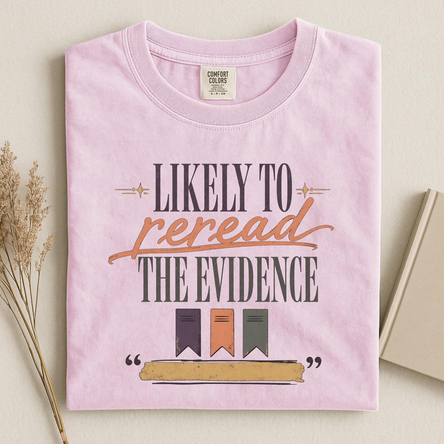 Likely to Reread the Evidence bookish tee in Blossom, flat lay