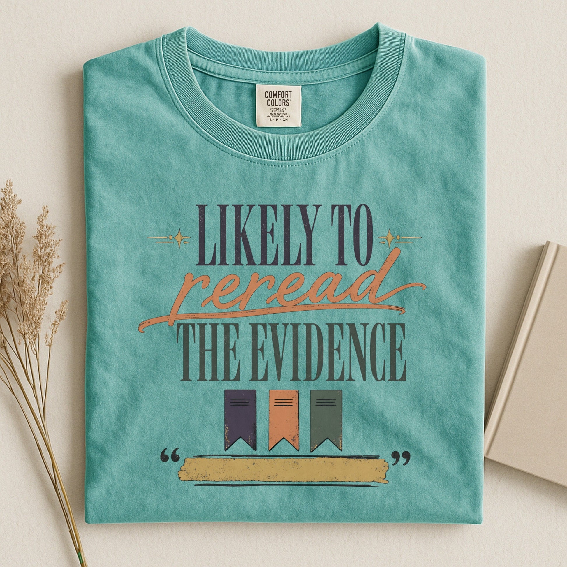 Likely to Reread the Evidence bookish tee in Seafoam, flat lay