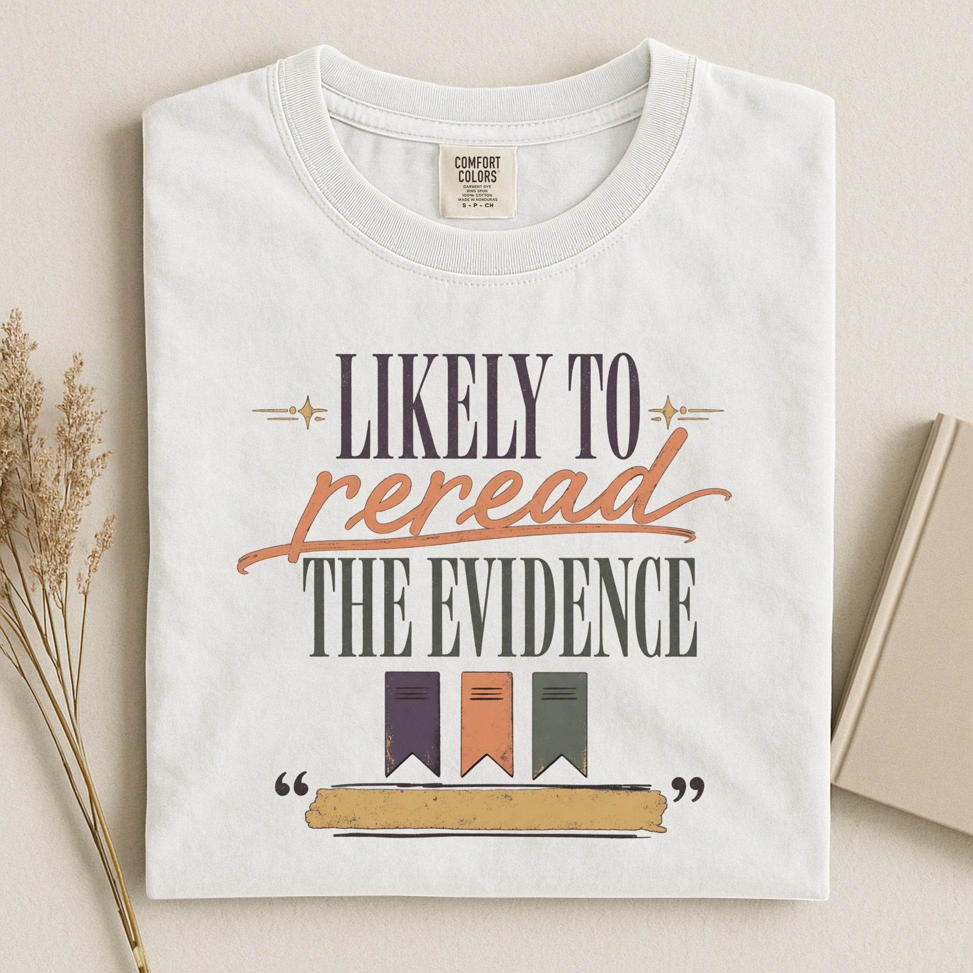 Likely to Reread the Evidence bookish tee in White, flat lay